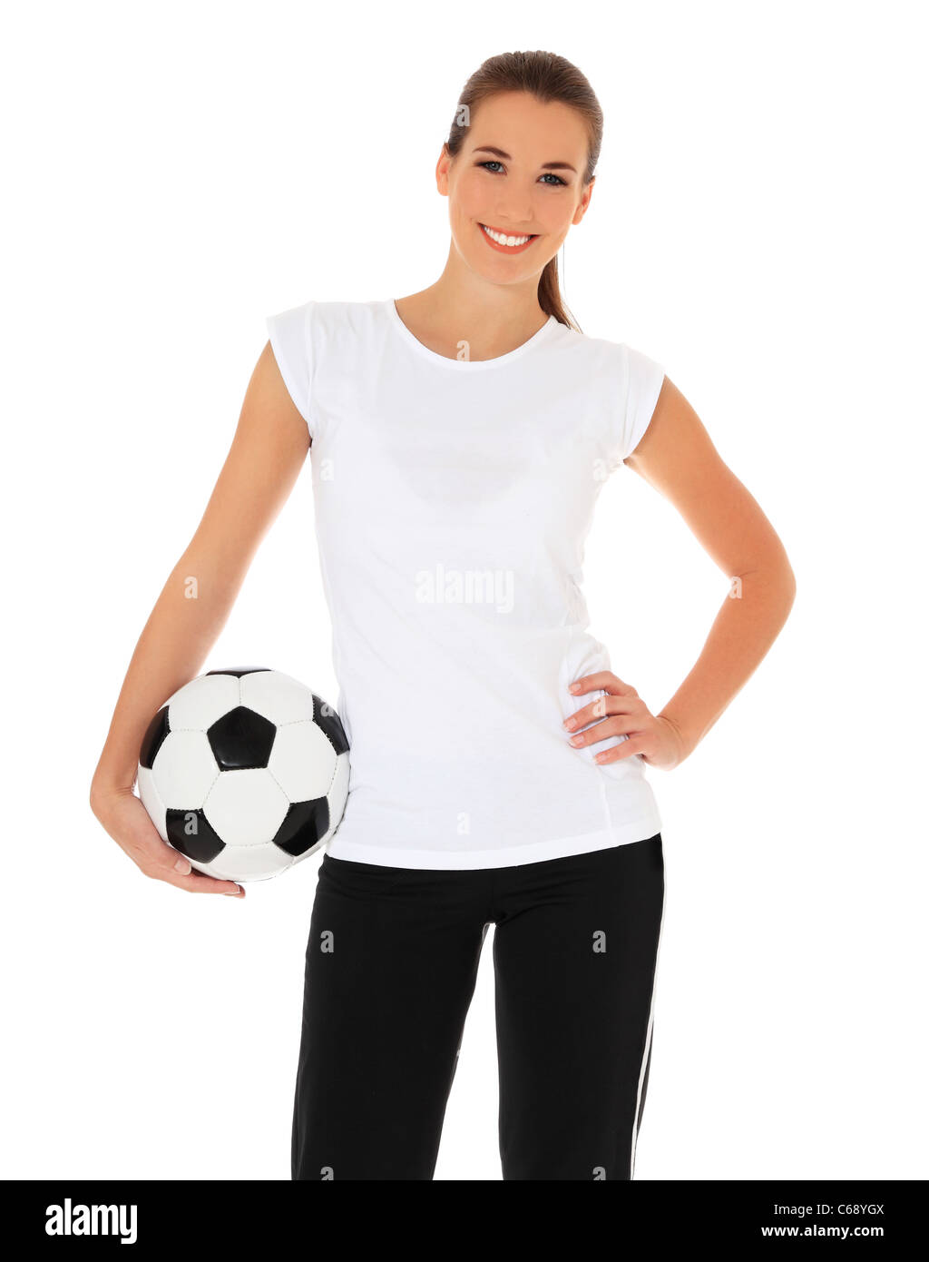Attractive young woman in sports wear holding soccer ball. Le tout sur fond blanc. Banque D'Images