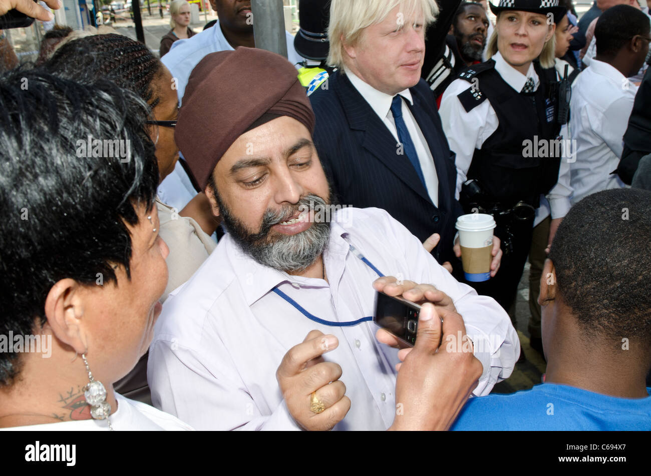 Montre homme Seikh photo de Boris Johnson à un ami, comme Johnson Maire de Londres répond aux foules après des émeutes de Croydon. Banque D'Images