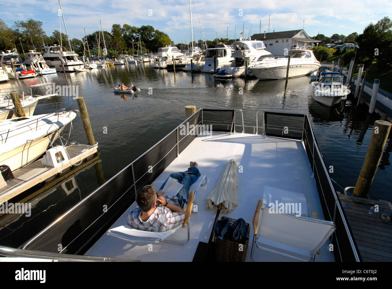 Propriétaire de bateau se détendre sur le pont à Sag Harbor Long island Banque D'Images