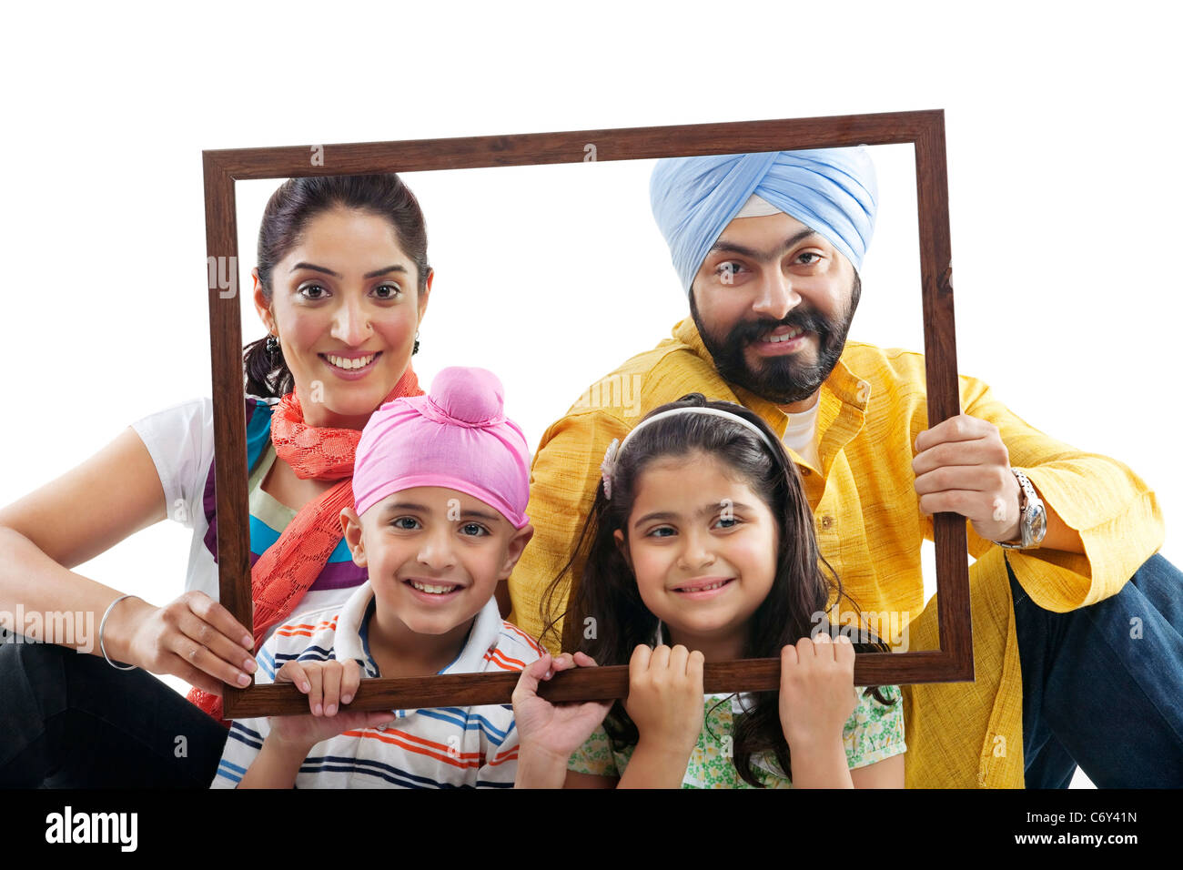 Portrait d'une famille sikh dans un cadre en bois Banque D'Images