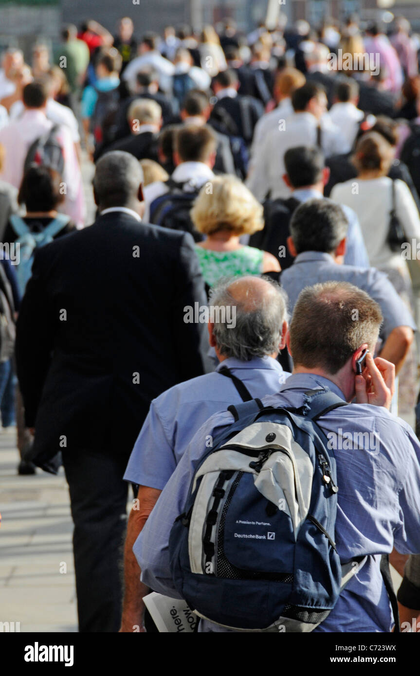 Scène de rue les gens les navetteurs sur London Bridge dos des hommes et femmes des employés de bureau à pied de la station London Bridge soirée ensoleillée Rush hour England UK Banque D'Images