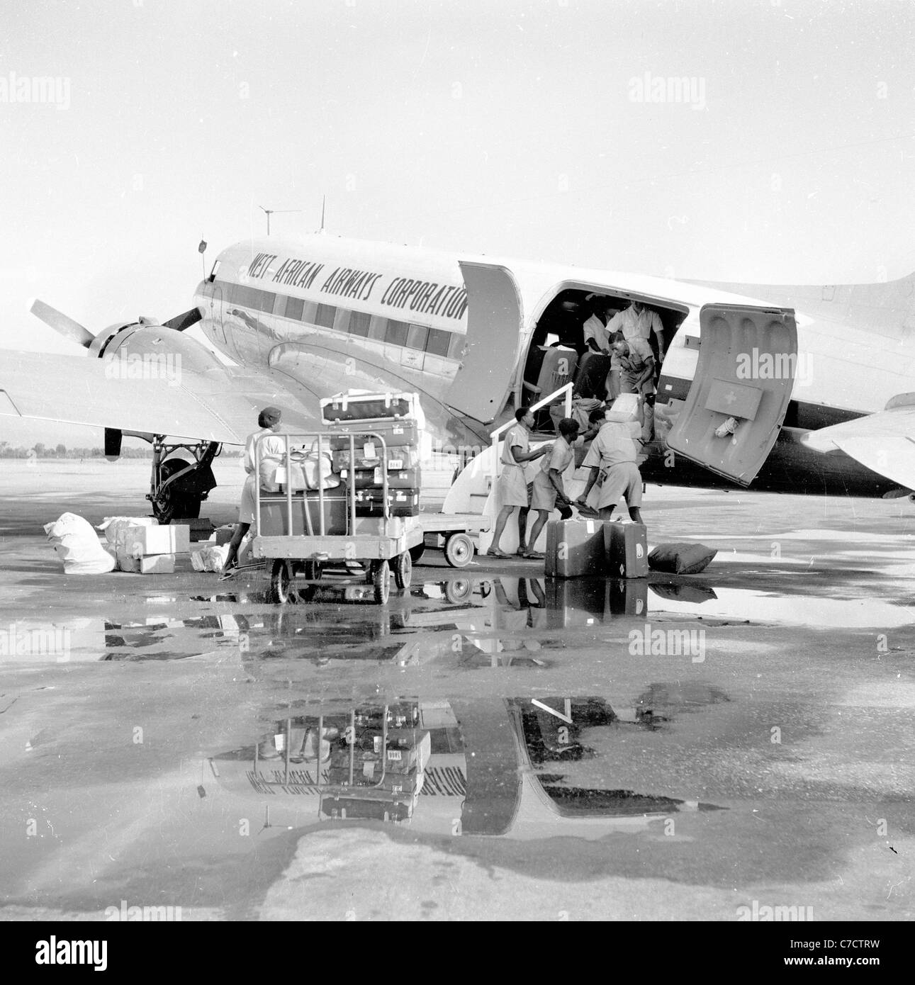 Le Nigeria, 1950. Le chargement des bagages d'une piste mouillée sur un aéronef de type hélice de l'Ouest African Airways Corporation. Banque D'Images