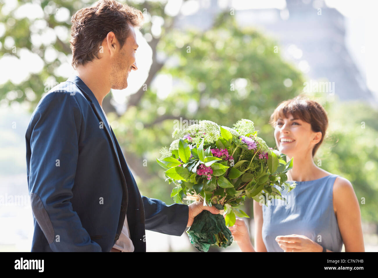 Homme Donnant à Un Bouquet De Fleurs à Une Femme Avec La