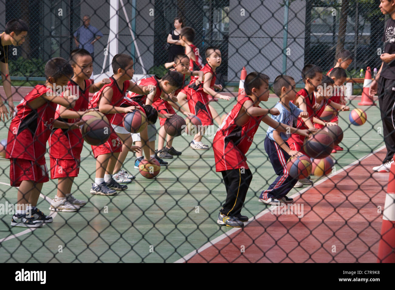 Enfants jouant au basket-ball à l'école, Guangzhou, Guangdong, Chine Banque D'Images