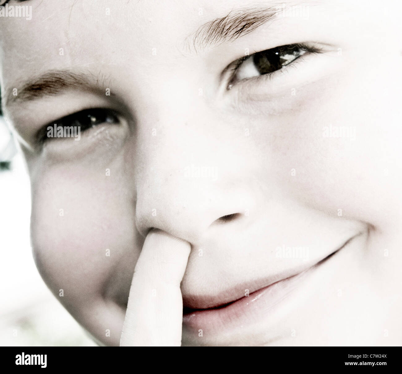 Close-up of a Boy picking son nez Banque D'Images