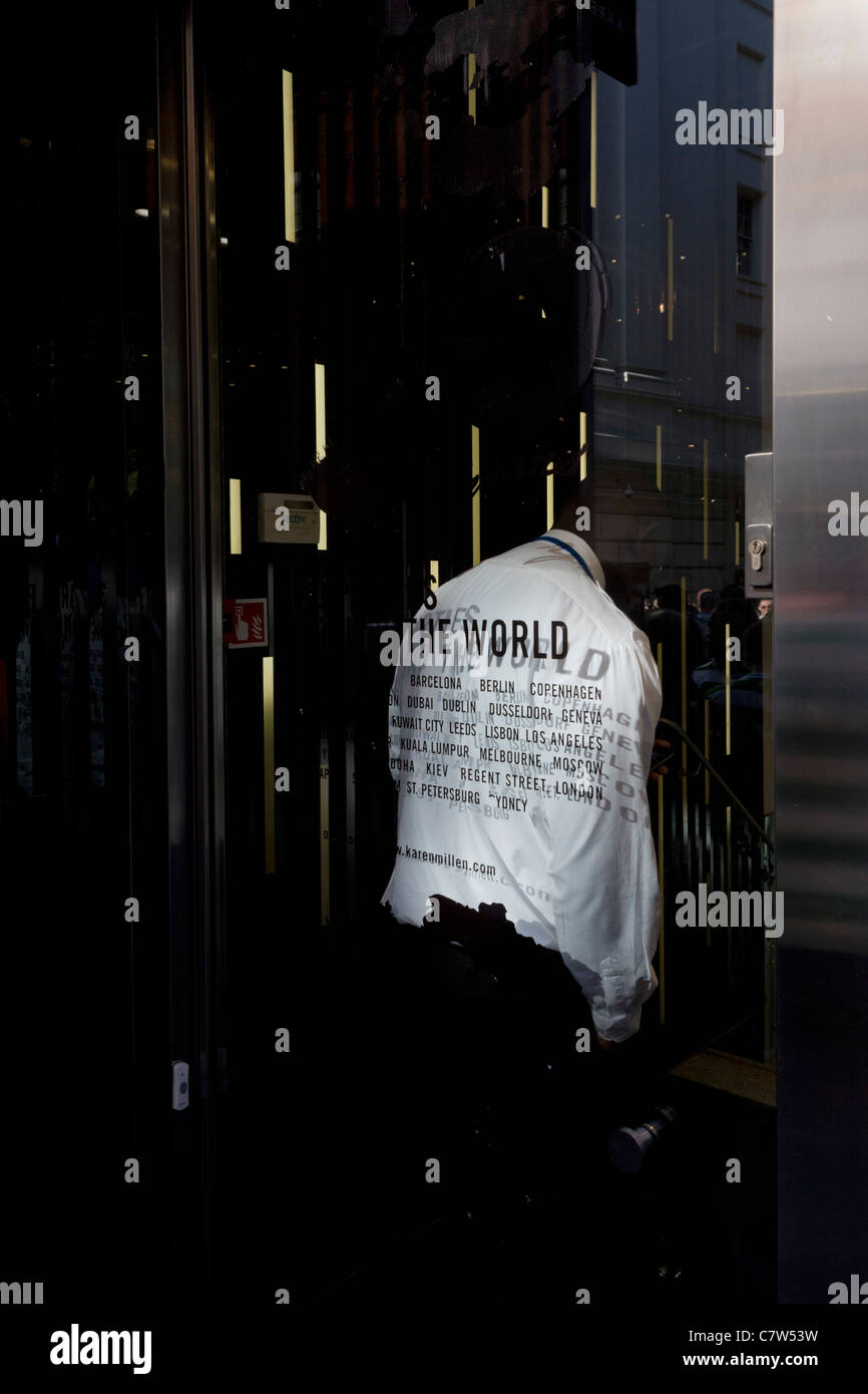 Un garde de sécurité se tient discrètement à proximité de la sortie d'une succursale de la marque de vêtements Karen Millen dans le centre de Londres. Banque D'Images