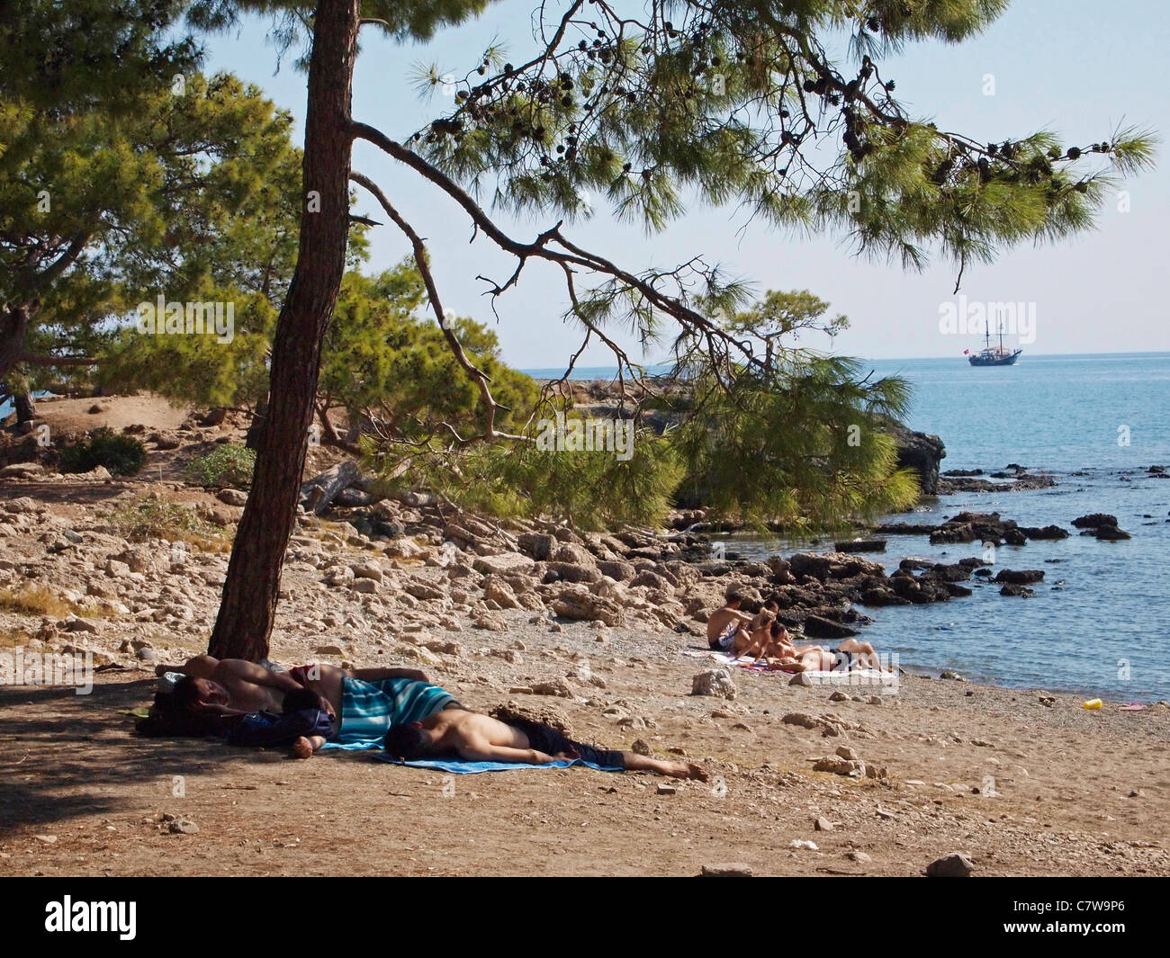 BAINS DE SOLEIL SUR ROCKY BEACH LA VILLE LYIAN DE PHASELIS PRÈS DE KEMER TURQUIE Banque D'Images