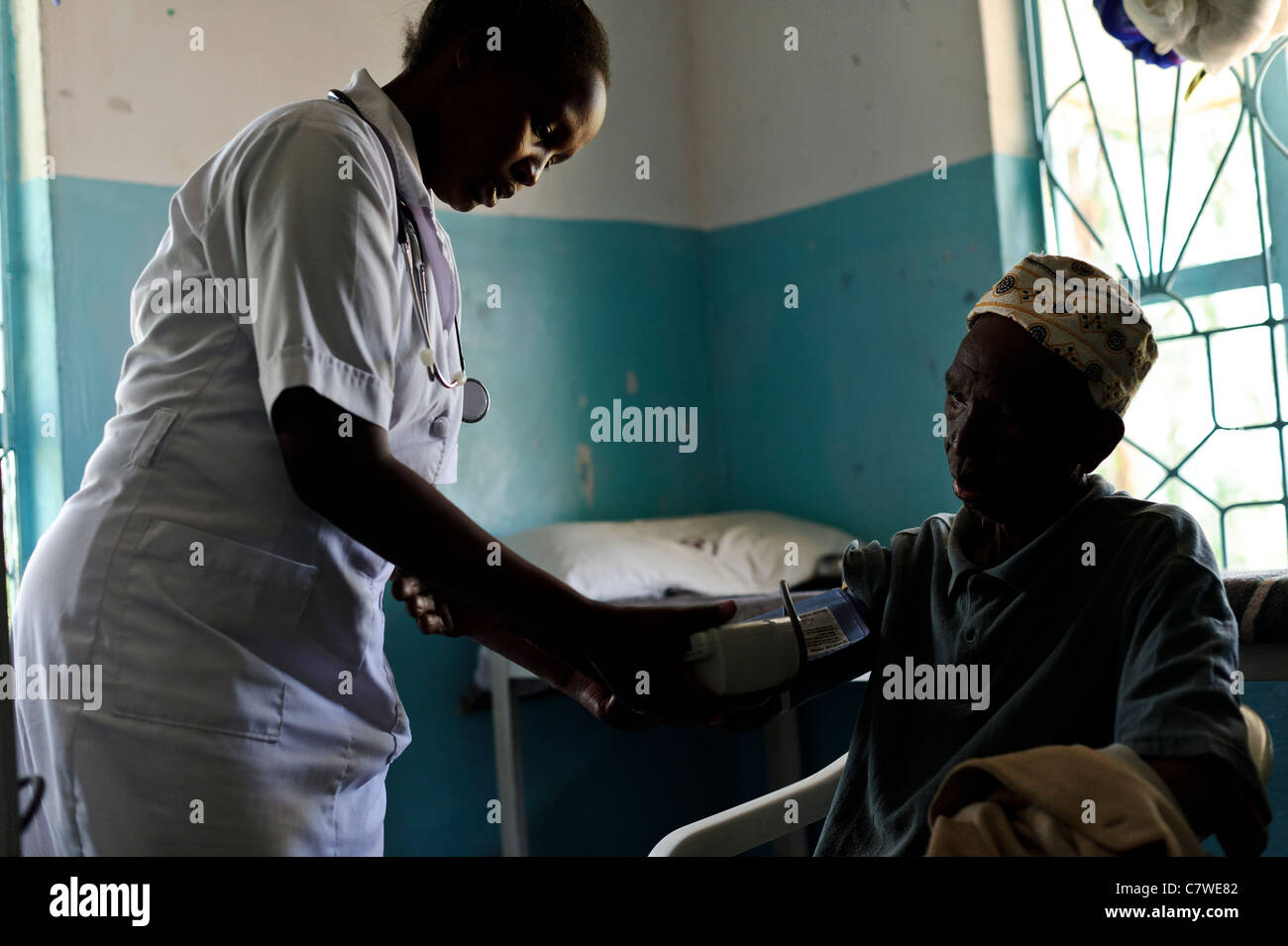 Une infirmière examine un homme âgé masai patient dans une clinique médicale gratuite, la Tanzanie, Canberra. Banque D'Images
