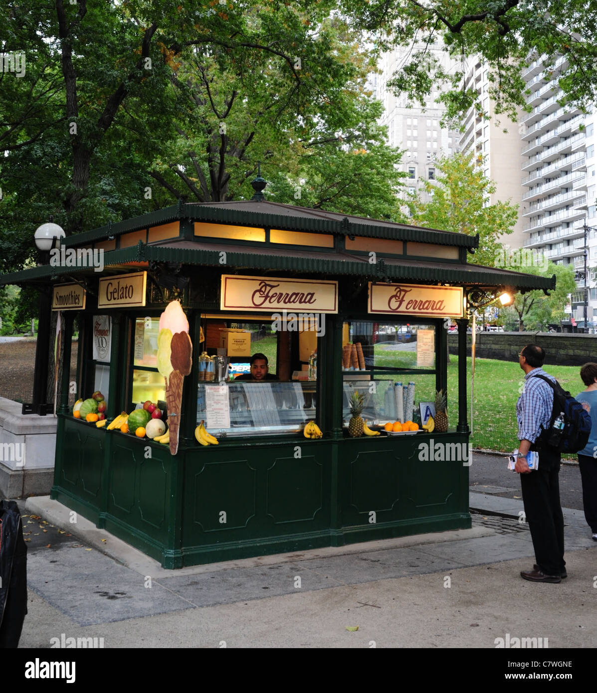 Man looking at Ferrara vert crème glacée café italien kiosque, Merchants' Gate Plaza, West Avenue, Central Park, New York City Banque D'Images