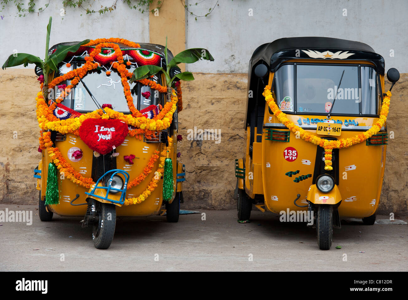 Rickshaw indien décorées de guirlandes de fleurs et de feuilles de bananier au cours de la fête hindoue du Dasara. L'Andhra Pradesh, Inde Banque D'Images