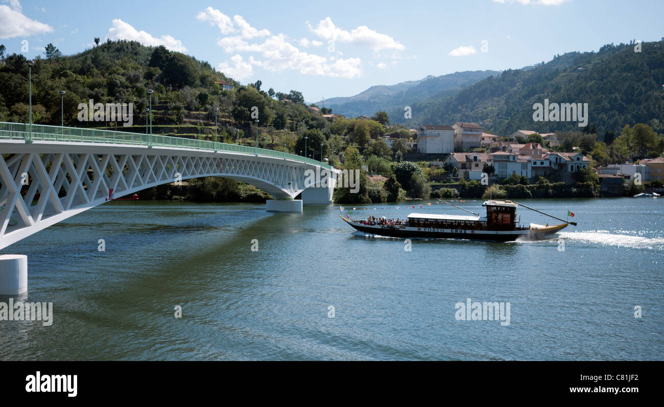 Un bateau de croisière sur le fleuve Douro pour passer sous la N222 pont à Porto Antigo, Portugal. Le Douro est un célèbre domaine viticole Banque D'Images