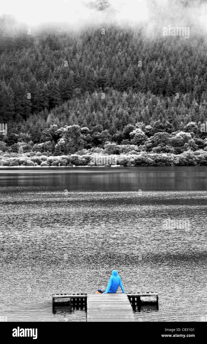 Une figure solitaire surplombant le lac Bassenthwaite, Lake District. Banque D'Images