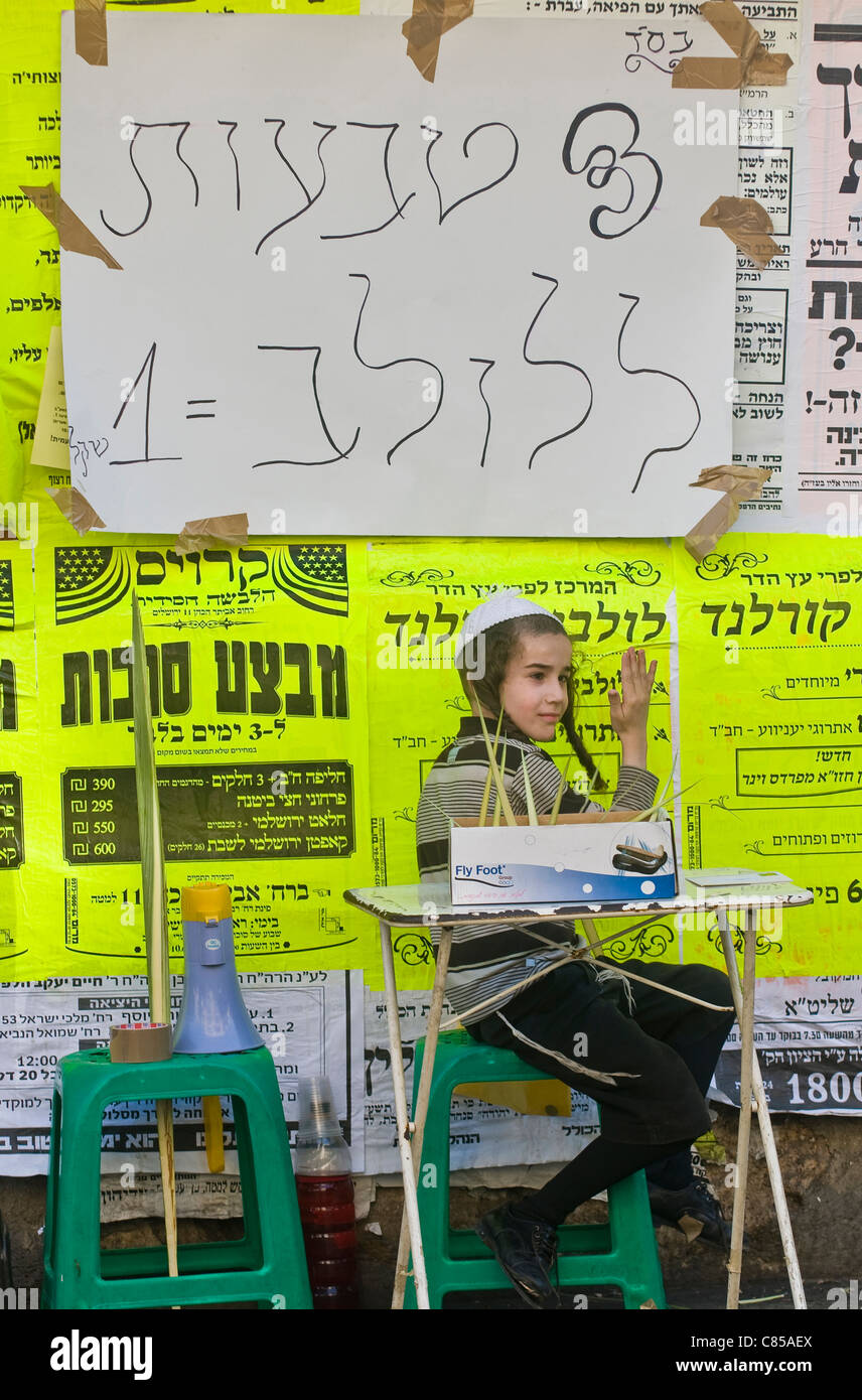 Un enfant juif ultra-orthodoxe du loulav vend bague dans le spesies marché 'Quatre' à Jérusalem Israël Banque D'Images