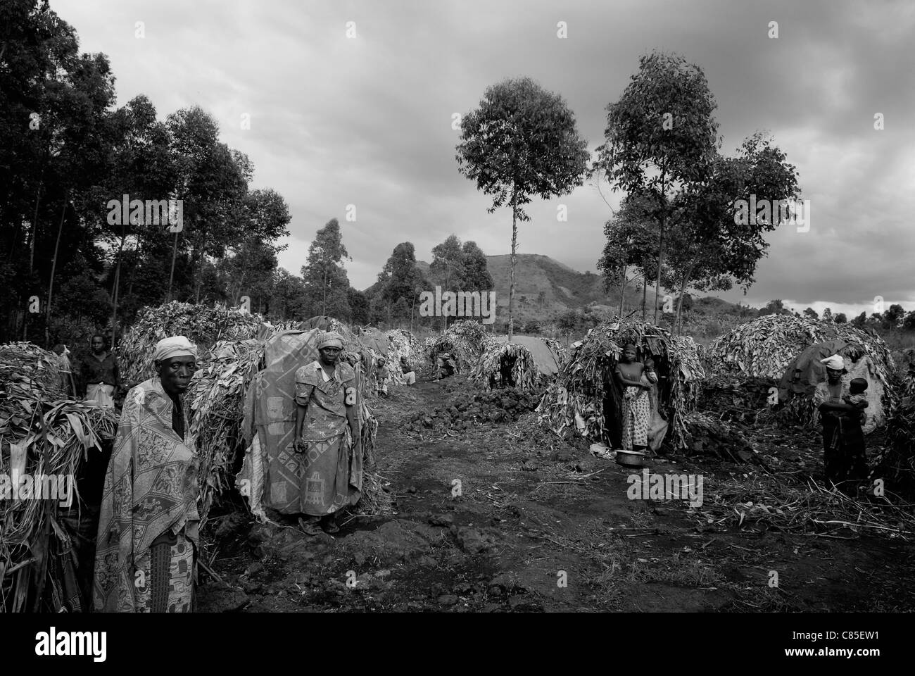 Un groupe de femmes congolaises déplacées à l'intérieur du pays se trouve devant des cabanes de paille de fortune dans un camp de déplacés de fortune au Nord-Kivu, en RD Congo, en Afrique Banque D'Images