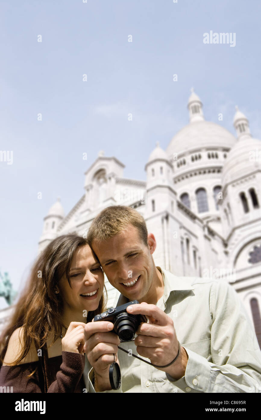 Visites couple looking at digital camera, Sacré Coeur, Montmartre, Paris, France Banque D'Images