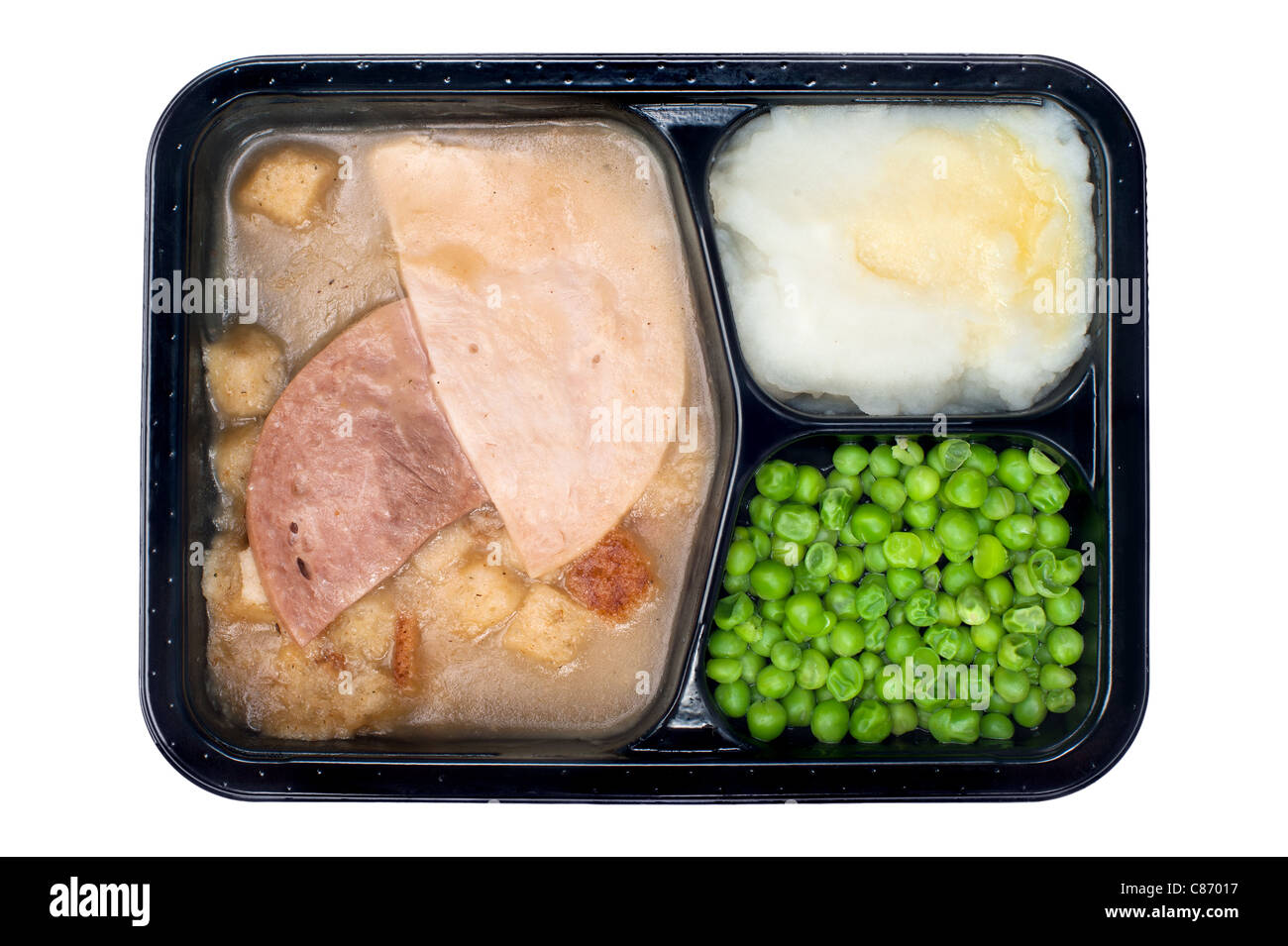 Un plat le dîner composé de dinde, jambon, petits pois et de la purée de pomme isolated on white Banque D'Images