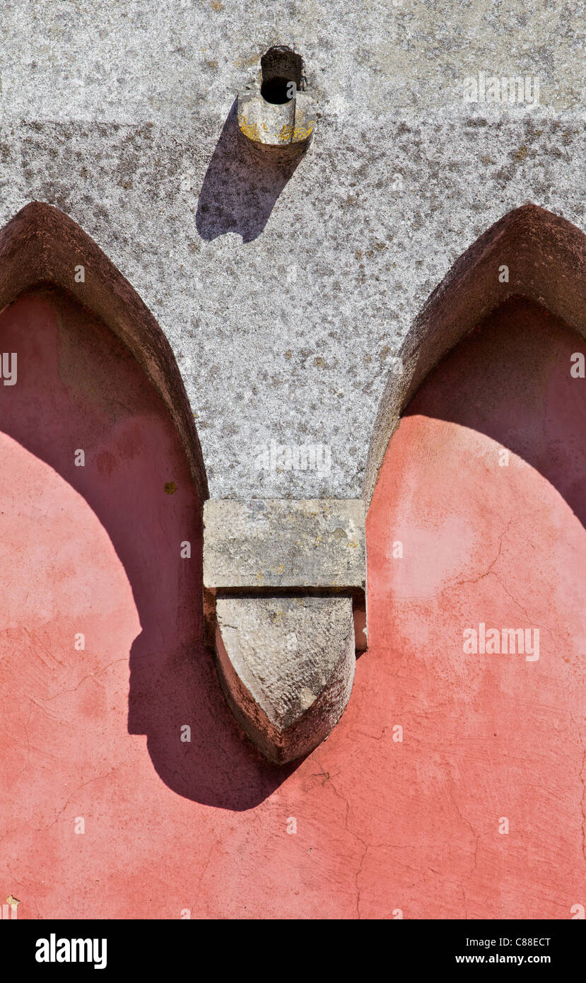 Conception d'ornements en pierre sculptée sur un mur de plâtre délavées rouge Banque D'Images