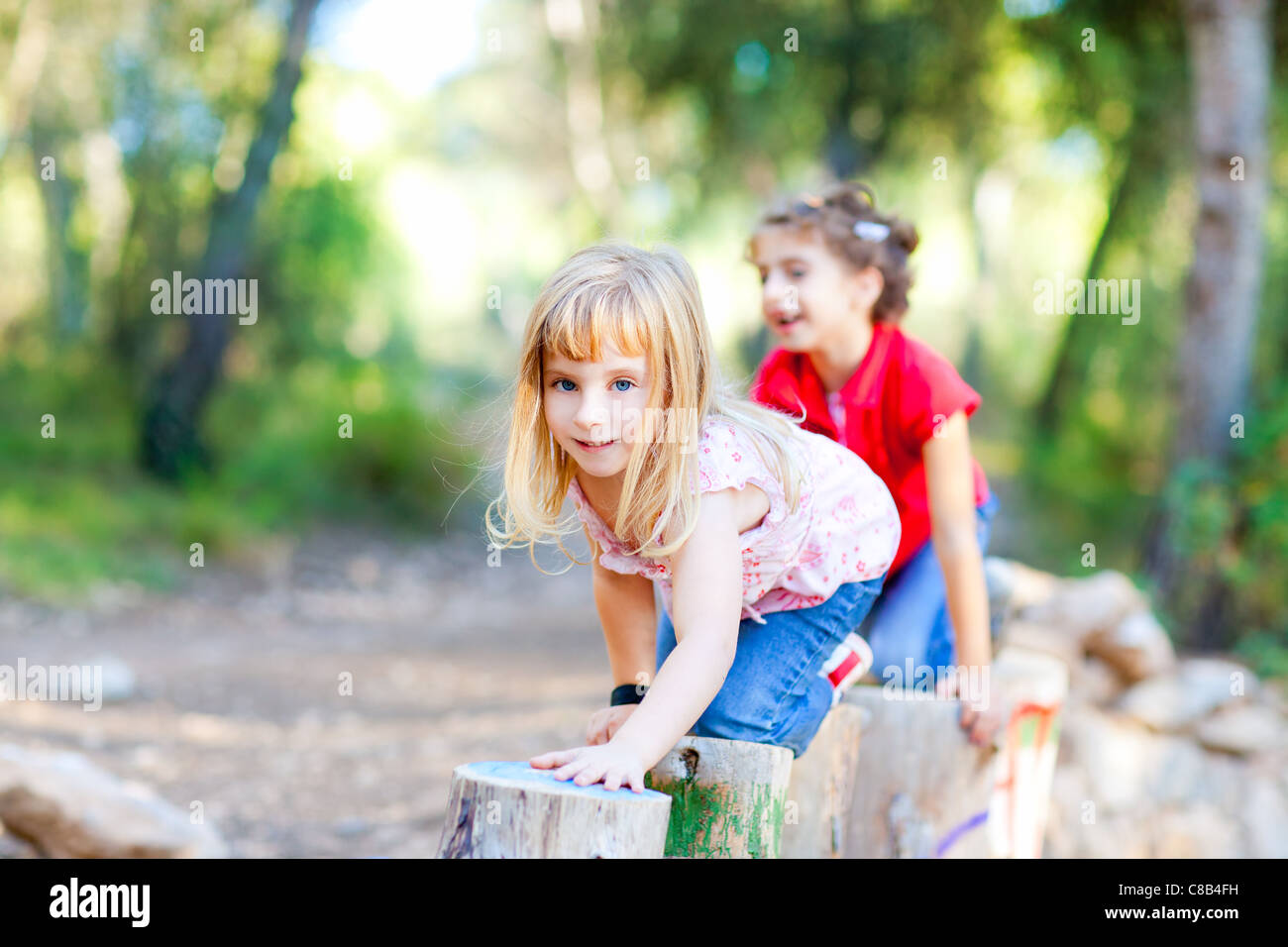 Kid de jeunes filles, jouant sur les lignes de marche du genou dans la nature des forêts Banque D'Images