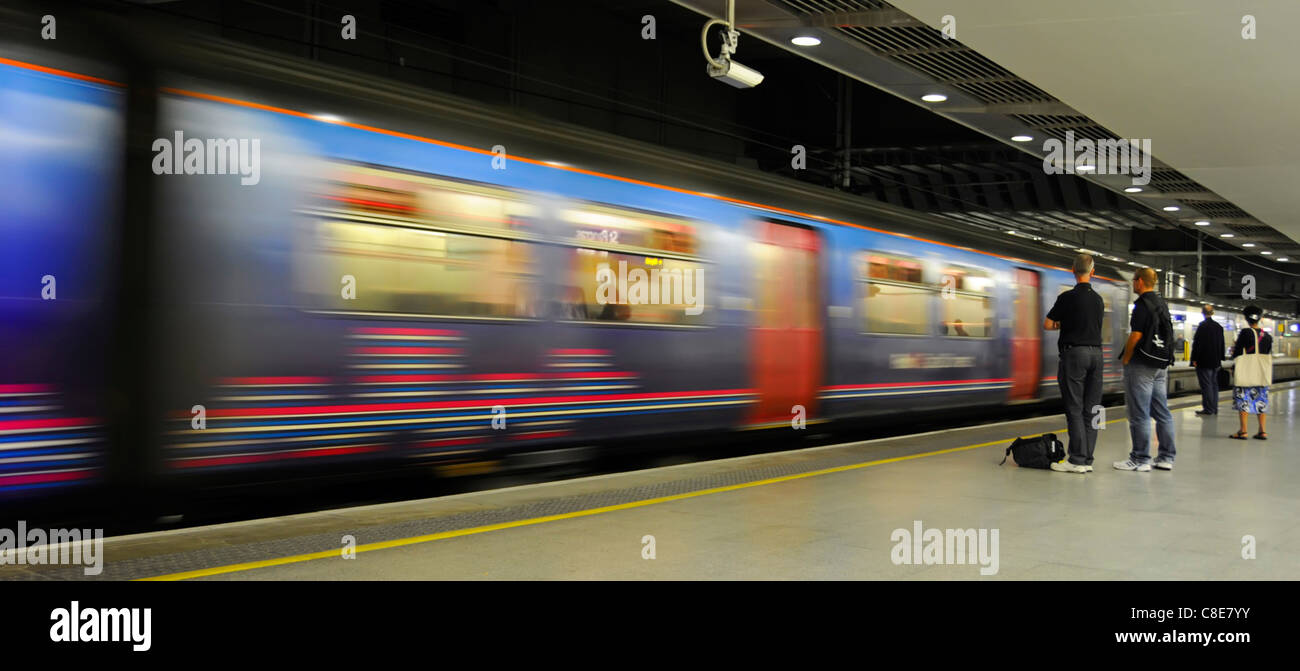 Flou de mouvement de train en mouvement et passagers sur la plate-forme à St Pancras International Station ferroviaire de bas niveau sur les services London Thameslink England UK Banque D'Images