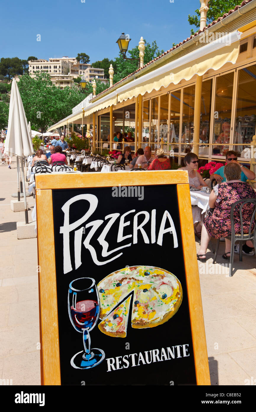 Restaurant pizzeria en plein air avec les visiteurs appréciant le déjeuner sur la terrasse ensoleillée en Port de Soller Majorque Espagne Banque D'Images
