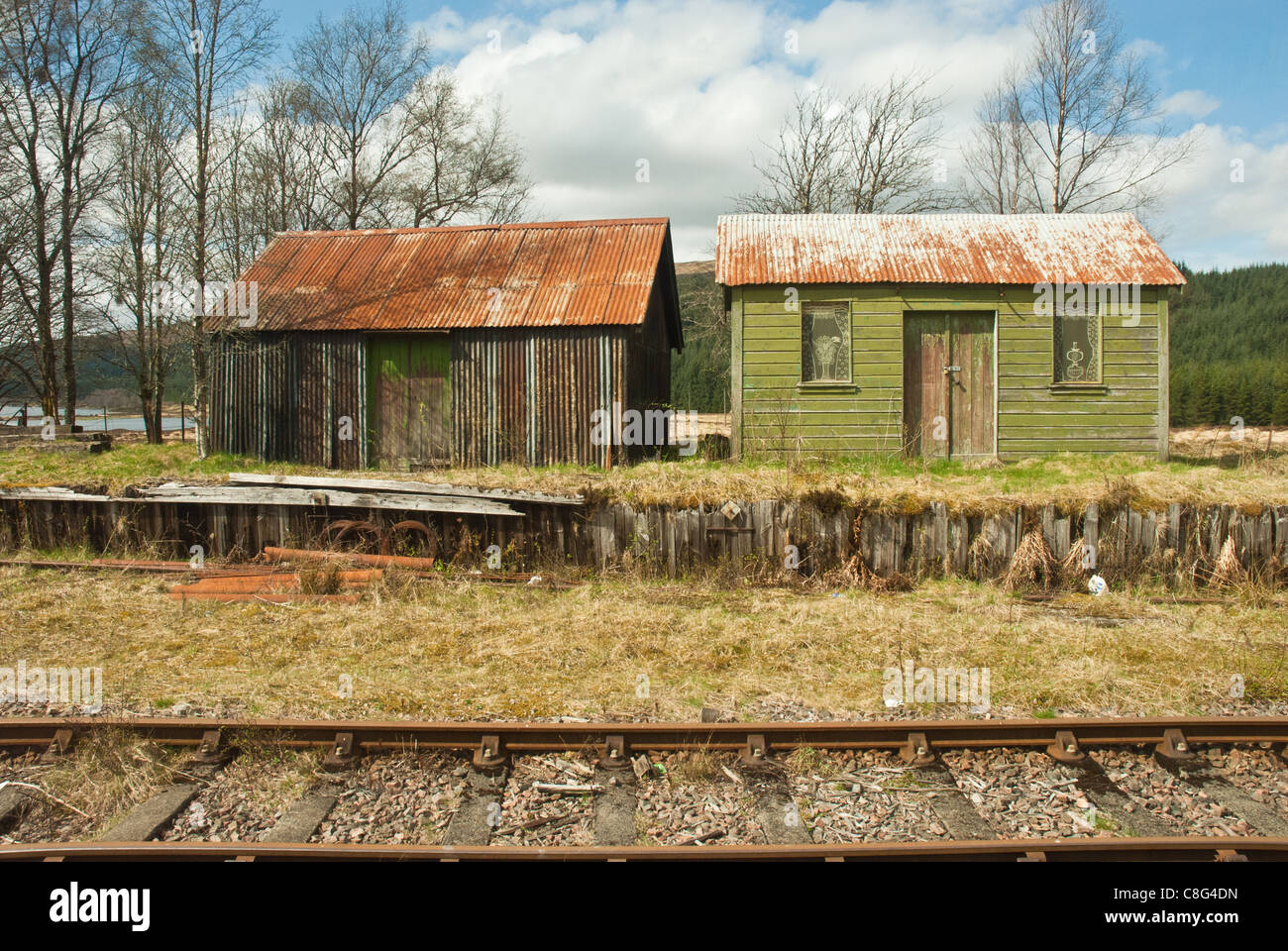 West Highland Railway. Les travailleurs des chemins de fer rustique huttes dans sunshine avec la voie ferrée en premier plan. Banque D'Images