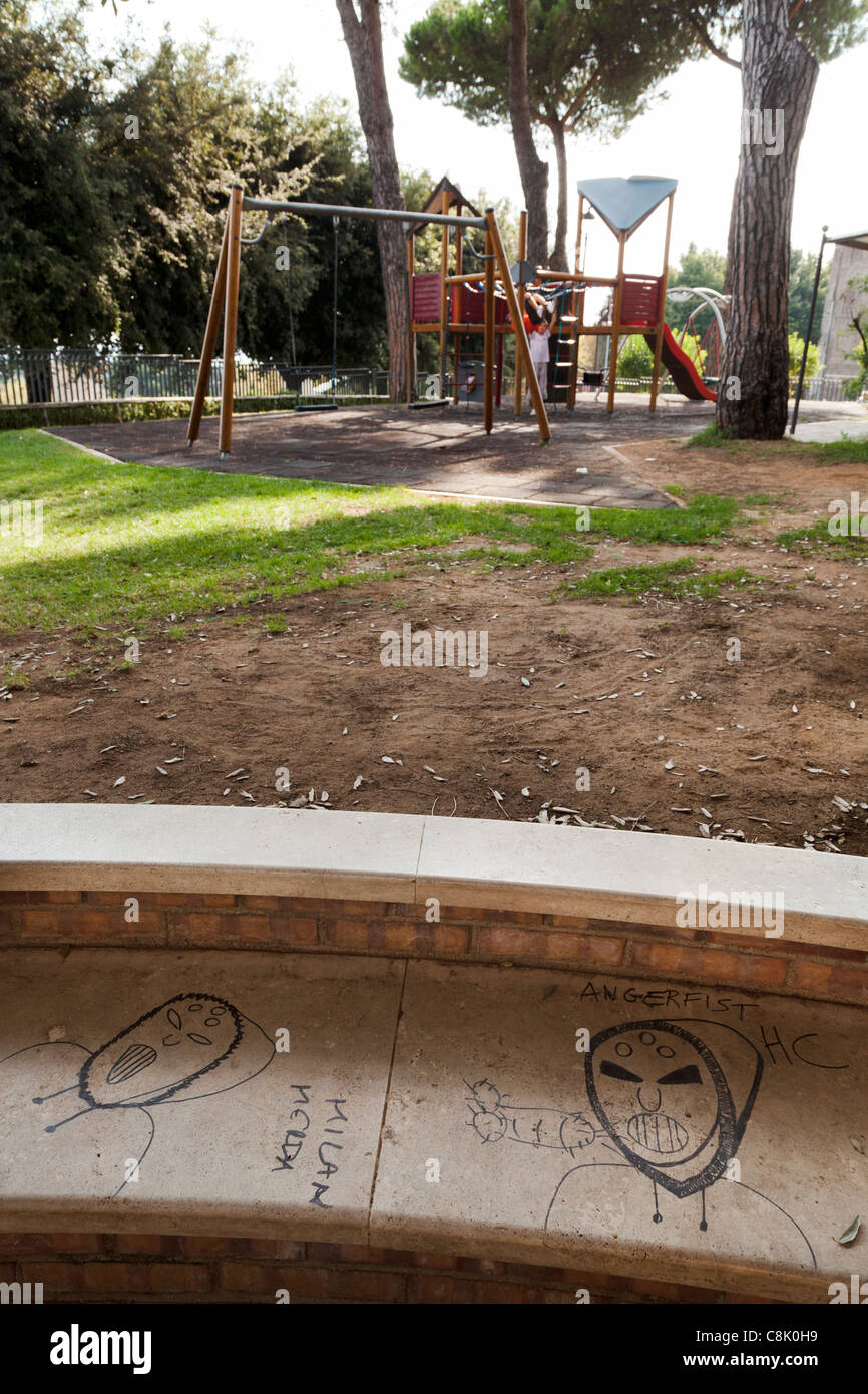 Graffiti sur le béton banc de parc avec balançoires et d''escalade Banque D'Images
