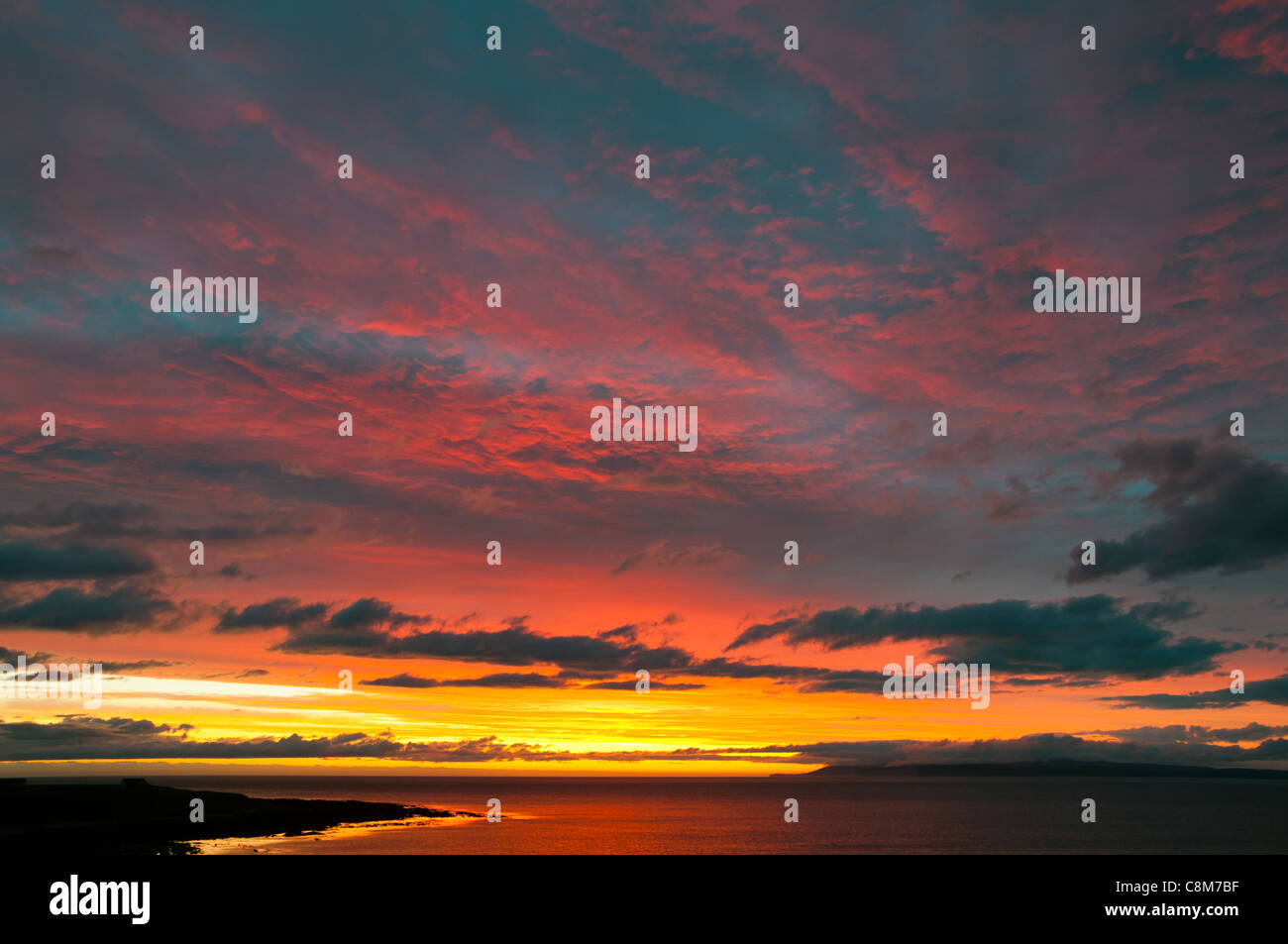 Coucher de soleil sur la Pentland Firth depuis Caithness sur la côte nord de l'Écosse, Royaume-Uni. Quelques jours après le milieu de l'été. L'île de Hoy, Orkney, à l'horizon. Banque D'Images