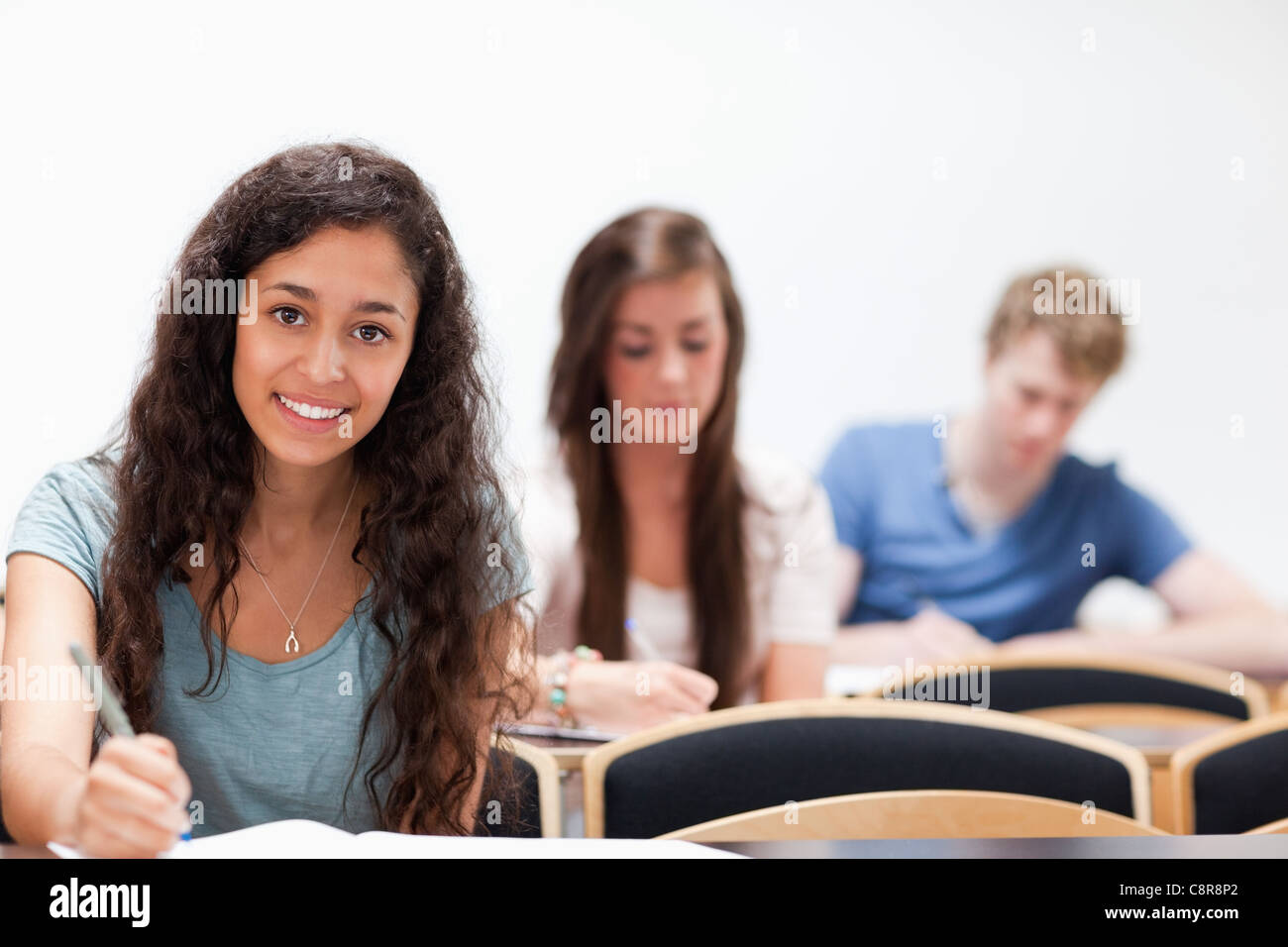 Smiling young students sitting Banque D'Images