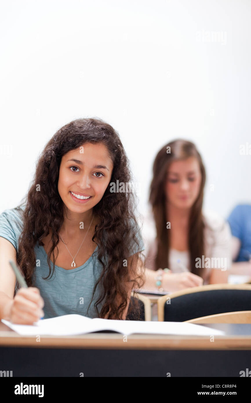 Portrait smiling young students sitting Banque D'Images