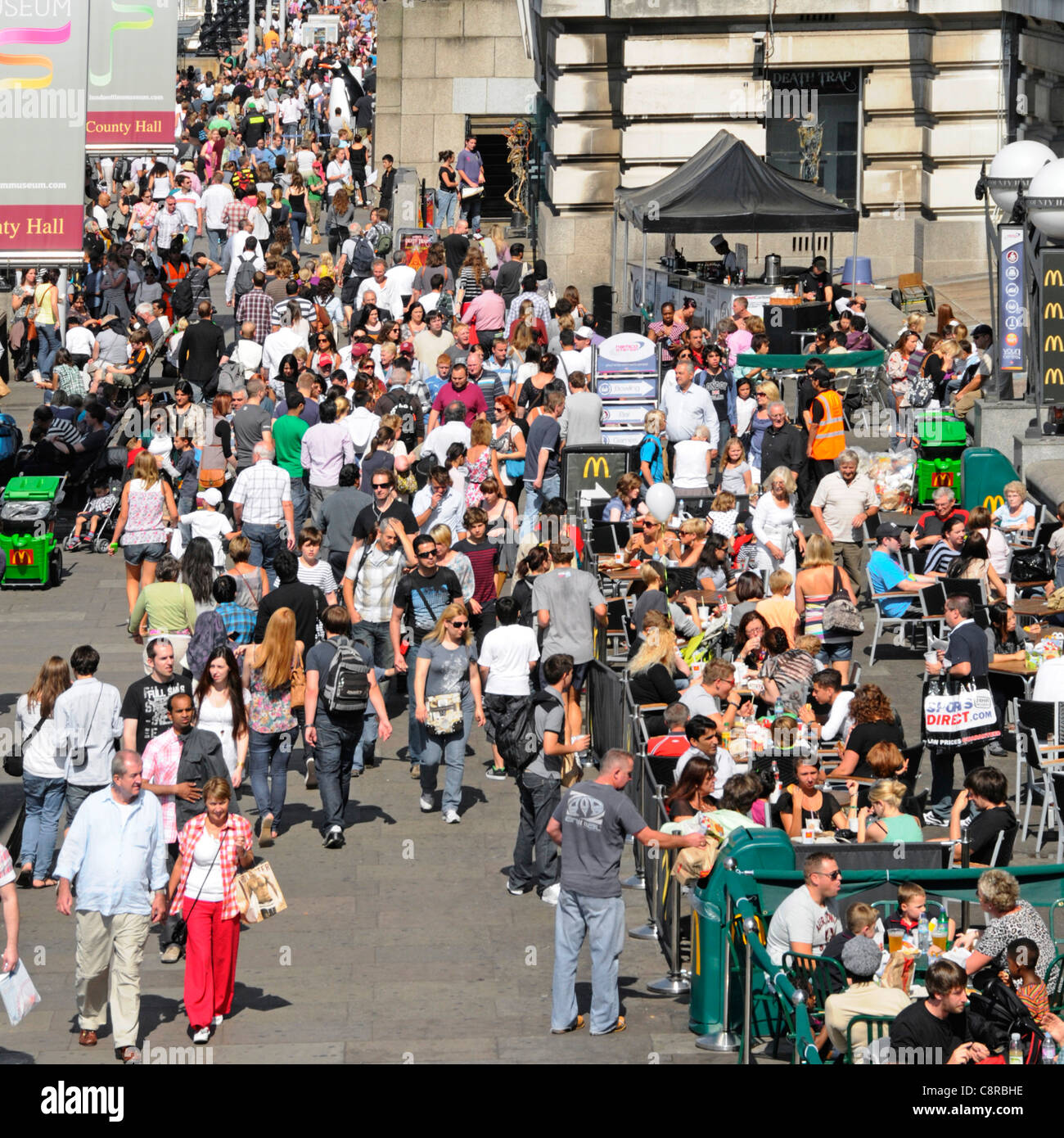 La foule des visiteurs d'été et les touristes sur la Tamise à l'extérieur de la vieille digue du County Hall Banque D'Images