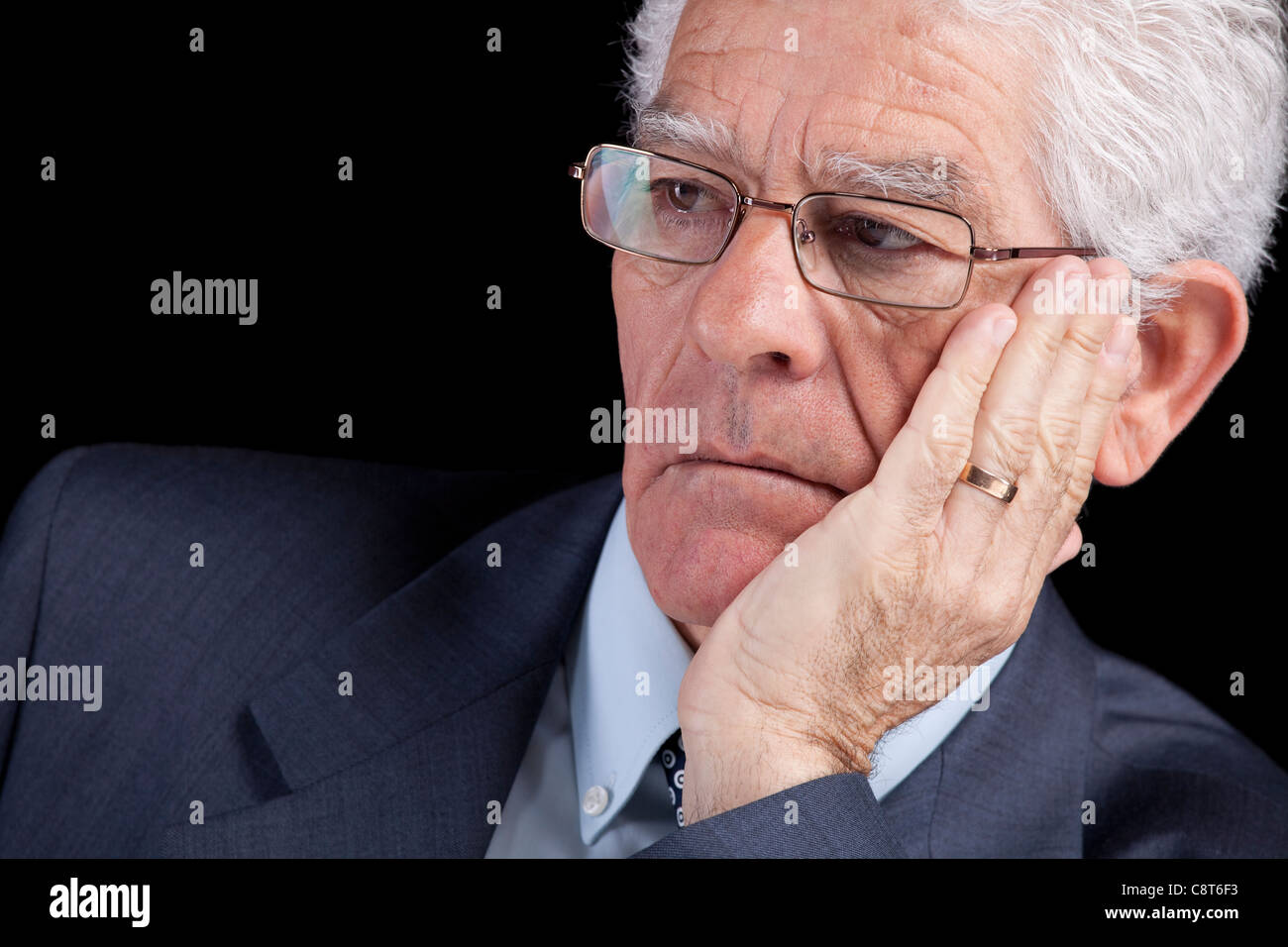 Senior businessman thinking avec sa main au menton (isolé sur fond noir) Banque D'Images