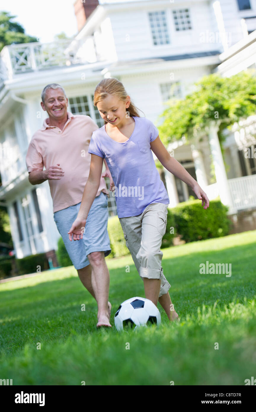 USA, New York State, Old Westbury, grand-père et sa petite-fille à jouer au soccer Banque D'Images