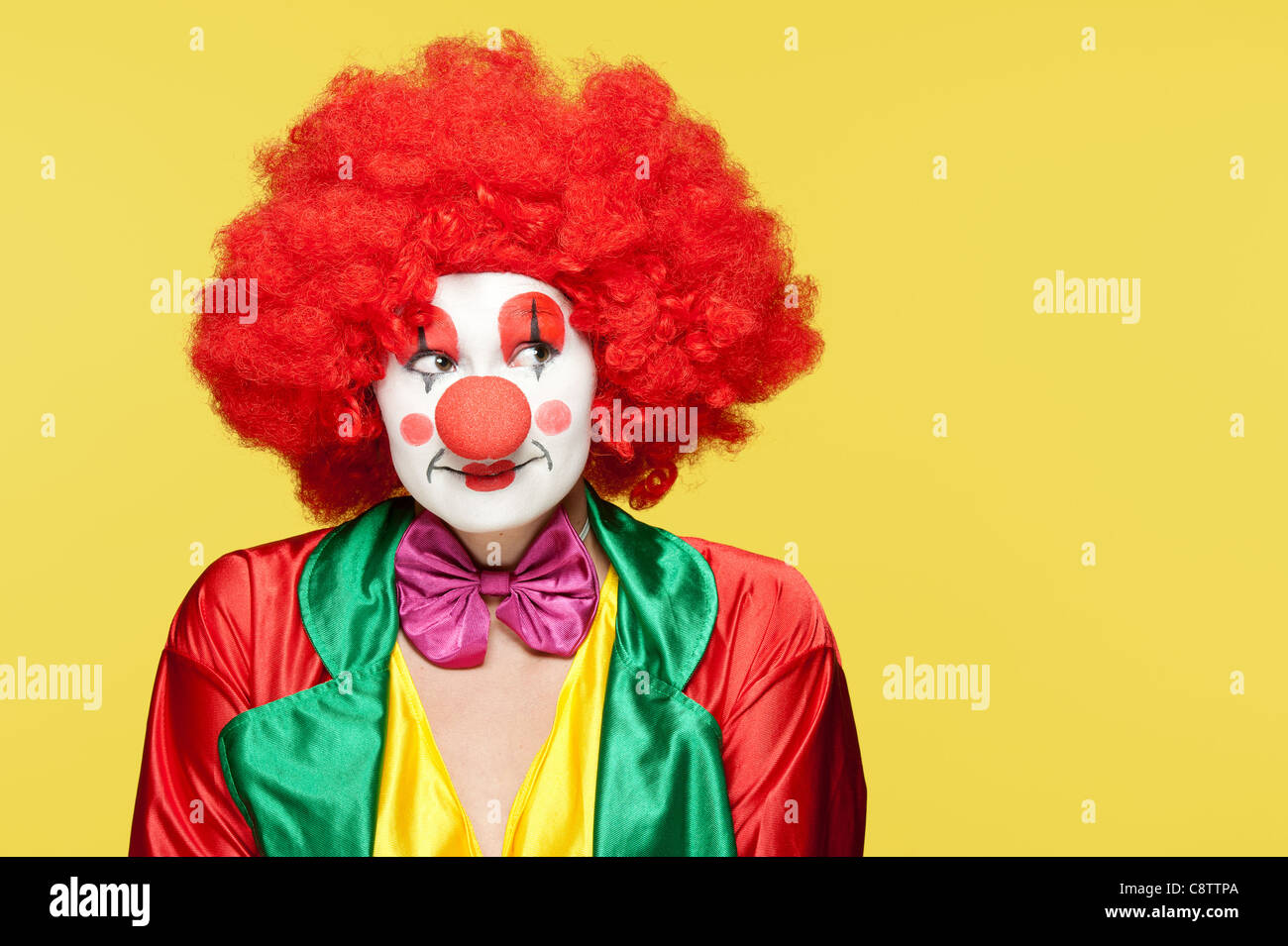 Un clown féminin avec des vêtements colorés et un miroir Banque D'Images