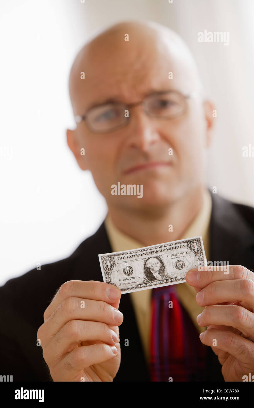 Portrait of business man holding one dollar bill Banque D'Images