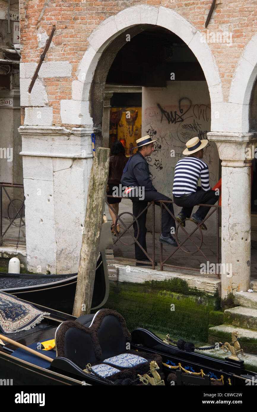 Gondoliers aux côtés de leurs gondoles à Venise Banque D'Images