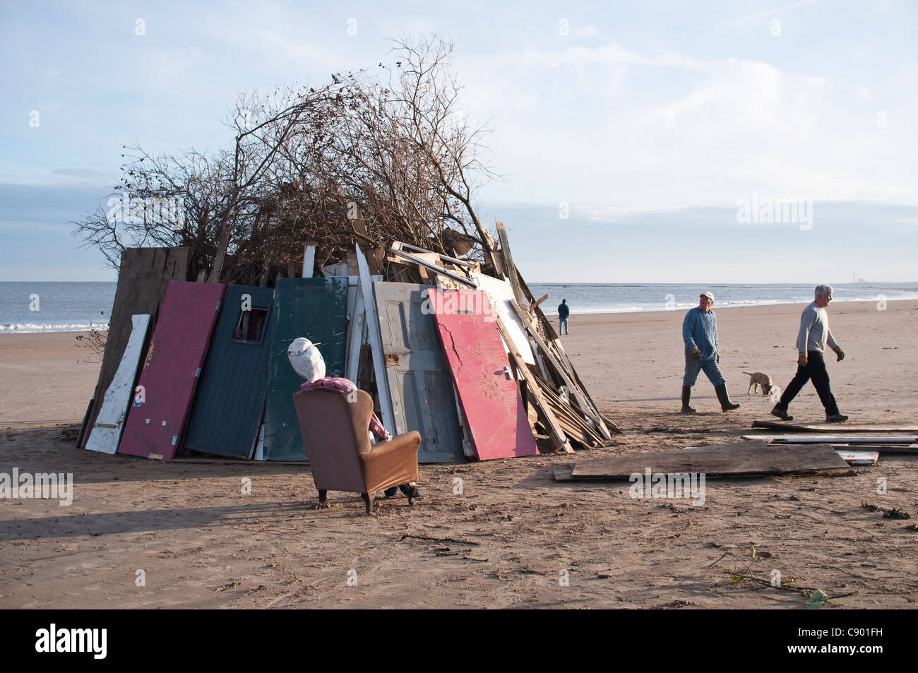 La construction d'un grand feu de joie sur la plage près de bas Hauxley dans le Northumberland, Royaume-Uni, le 5 novembre pour célébrer la nuit de Guy Fawkes. Banque D'Images