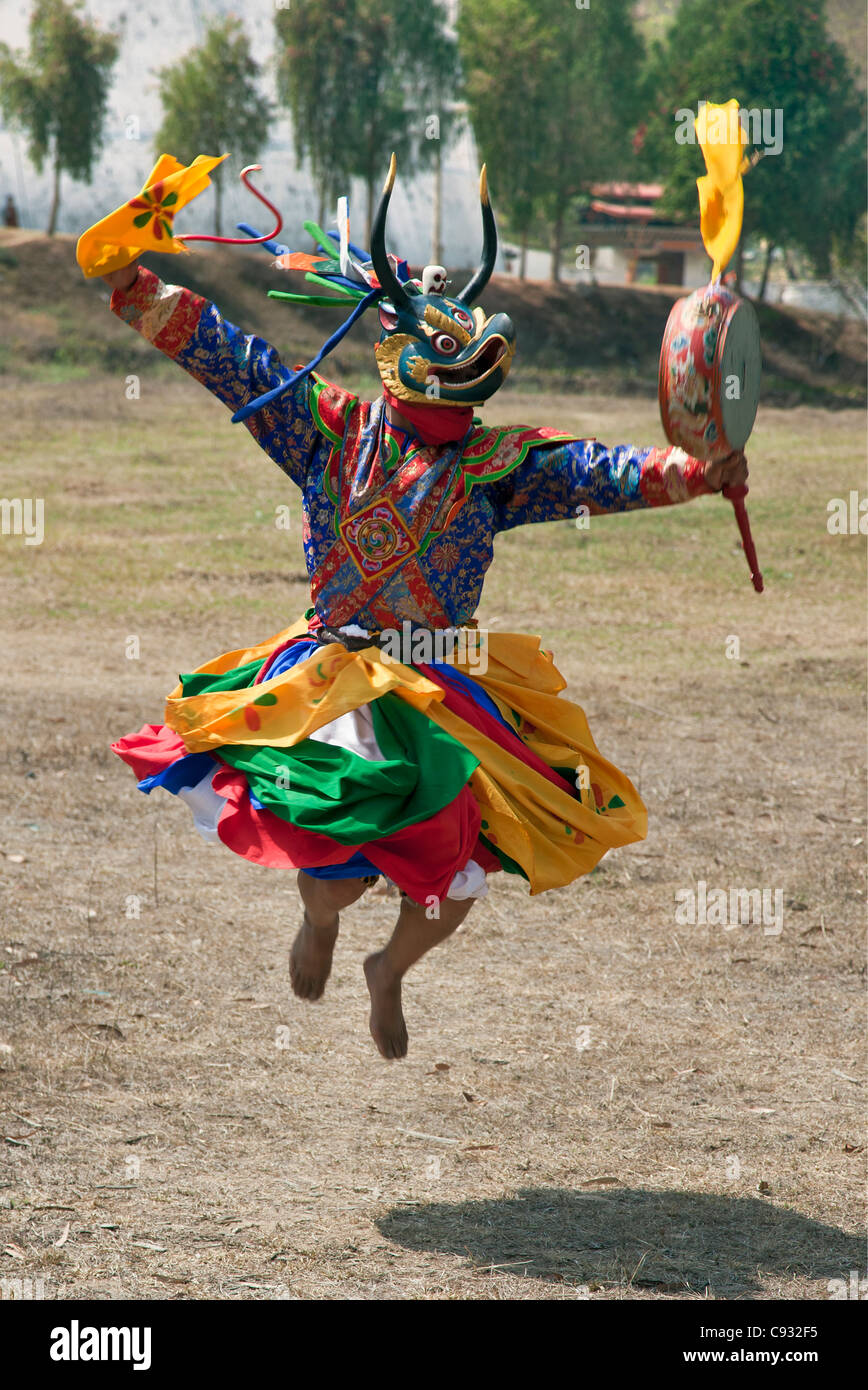 Un danseur masqué avec un lag nga saute haut dans les airs au cours de Drametse Nga Cham au monastère de Drametse dans l'Est du Bhoutan. Banque D'Images