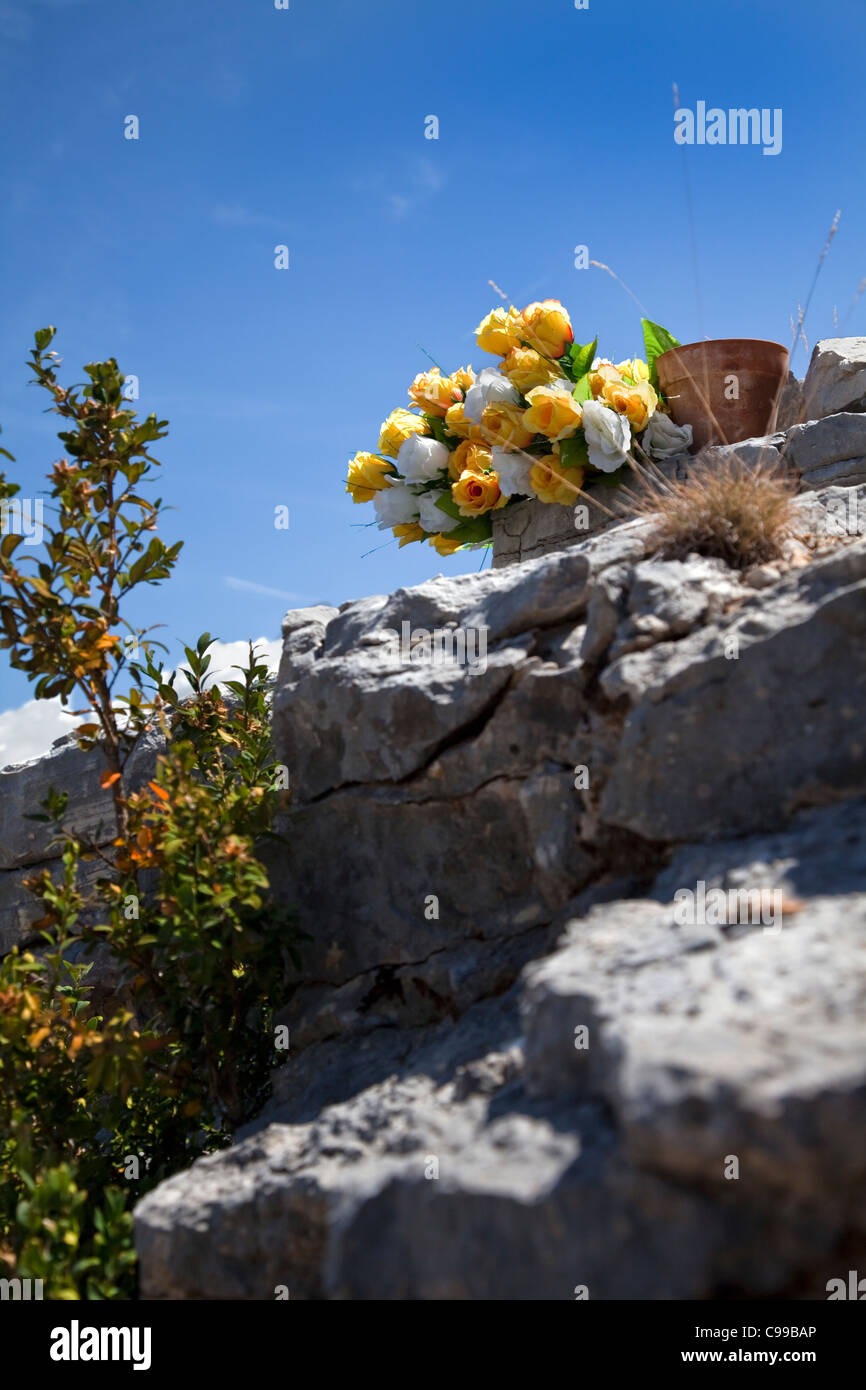 Fleurs placées dans un mémorial sur un rocher dans les gorges du Verdon, Alpes de Haute Provence, sud-est de la France. Banque D'Images