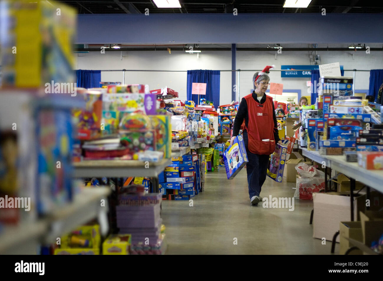 London, Ontario, Canada - le 8 décembre 2011. Cheryl Leyes promenades à travers les dons de jouets à l'Armée du Salut 2011 toy et centre de distribution de nourriture à l'intérieur de la construction au Western Fair District. Cette année, l'Armée du Salut s'attend à fournir de la nourriture et des paniers de jouets de plus de 5000 h Banque D'Images