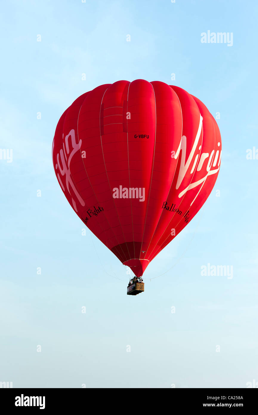 Un voyage en montgolfière décolle juste avant que le soleil se couche dans un beau temps de printemps à Longstanton, près de Cambridge le 23/3/12. La température atteignait 20 degrés Celsius sur comme heure d'été britannique est sur le point de commencer. Banque D'Images