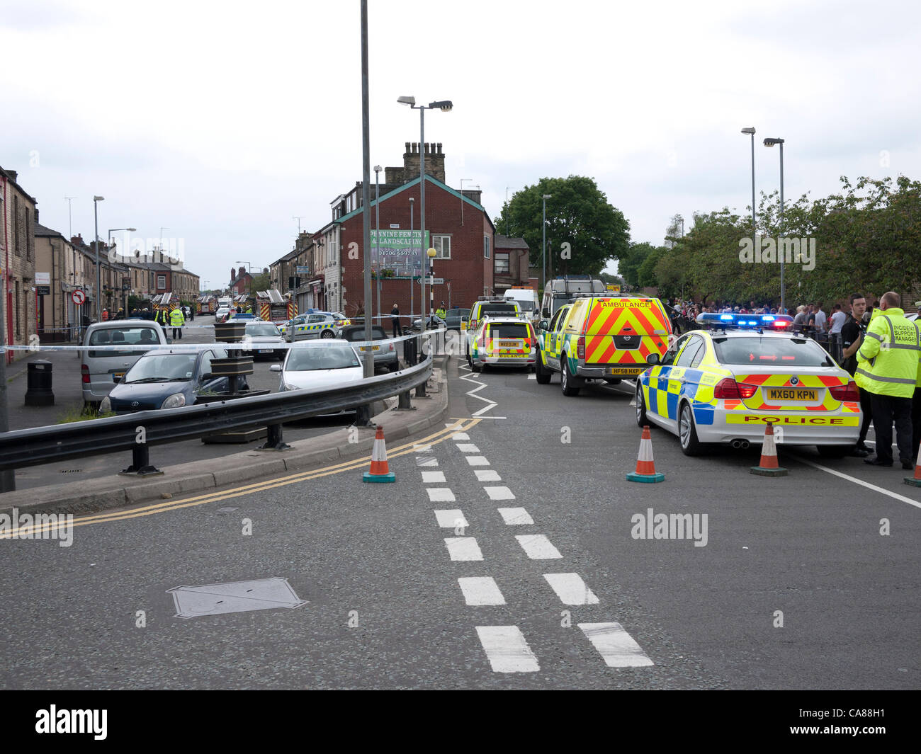 Oldham, grand Manchester, UK. 26 juin 2012. La police de la circulation et de remplir les rues de Crompton façon, une route à proximité de ce matin explosion d'une maison dans la région de Shaw d'Oldham. Un enfant est mort et un homme est pris au piège sous les décombres après un certain nombre de maisons ont été endommagées dans un cas présumé d'explosion de gaz dans la région de Oldham, la police a dit. Banque D'Images