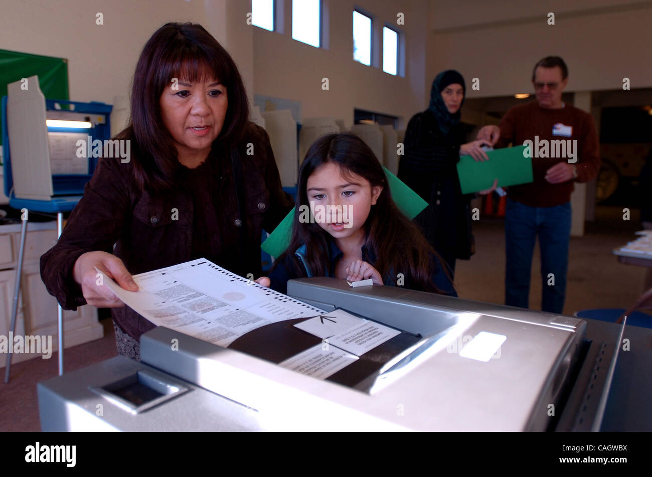 Lily Ellis, 8 montres, comme grand-mère Lori Ellis nourrit son bulletin dans l'urne le jour de l'élection à l'Église méthodiste dans Pinole, Californie le mardi 5 février 2008. (Kristopher Skinner/Contra Costa Times) Banque D'Images