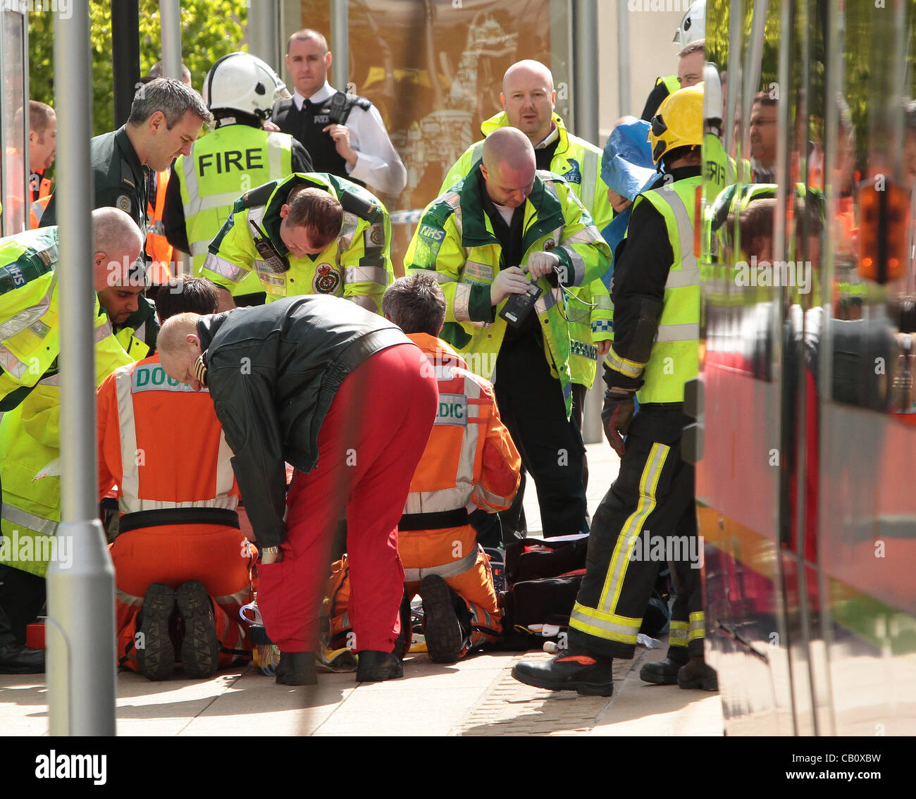 Croydon UK. 16 mai, 2012 . Une femme de 28 ans a été traîné 30m dans un tram à Croydon, dans le sud de Londres après avoir essayé de traverser les lignes de tram. Autour de 50 services d'urgence y compris les pompiers, ambulanciers et policiers étaient sur place pour extraire la victime de sous le tramway. Elle a été emmenée à l'hôpital par ambulance aérienne. Banque D'Images