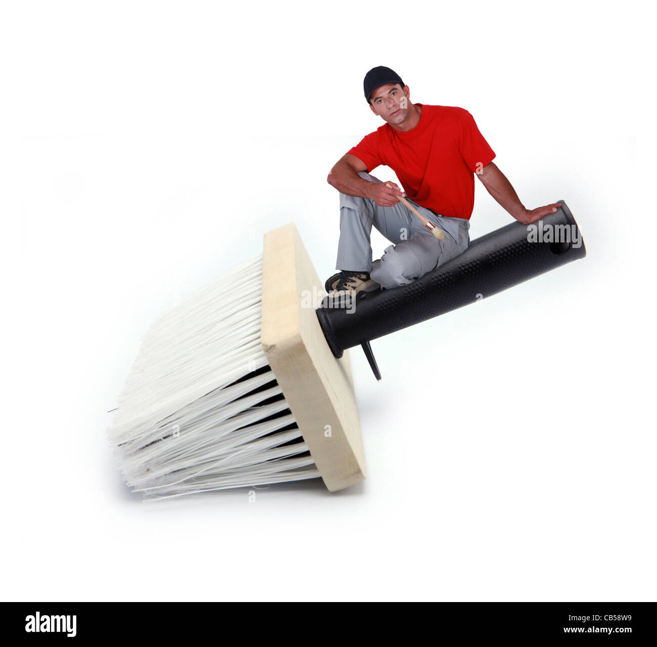 Assis sur un peintre pinceau géant, photo-montage Banque D'Images