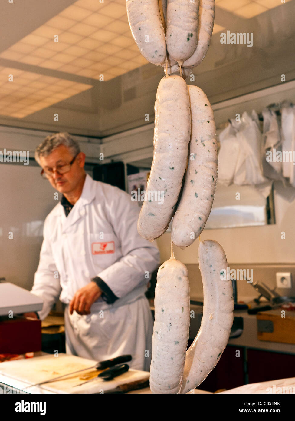 Boucher avec de la ficelle de saucisses de porc - France. Banque D'Images