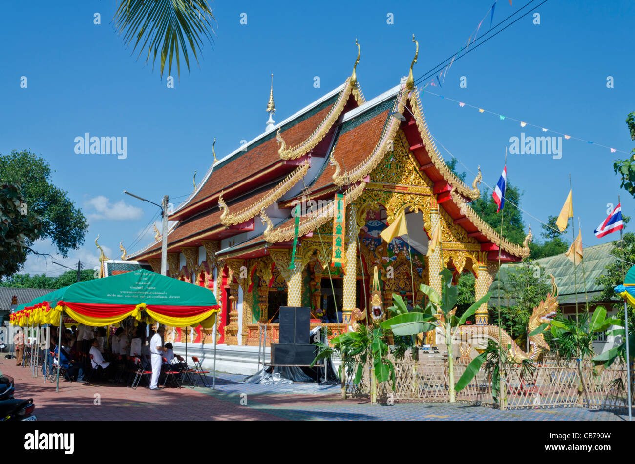 Loi Krathong festivités à un temple bouddhiste ensoleillée avec des bannières, banderoles, et le public dans le nord de la Thaïlande près de Chiang Mai Banque D'Images
