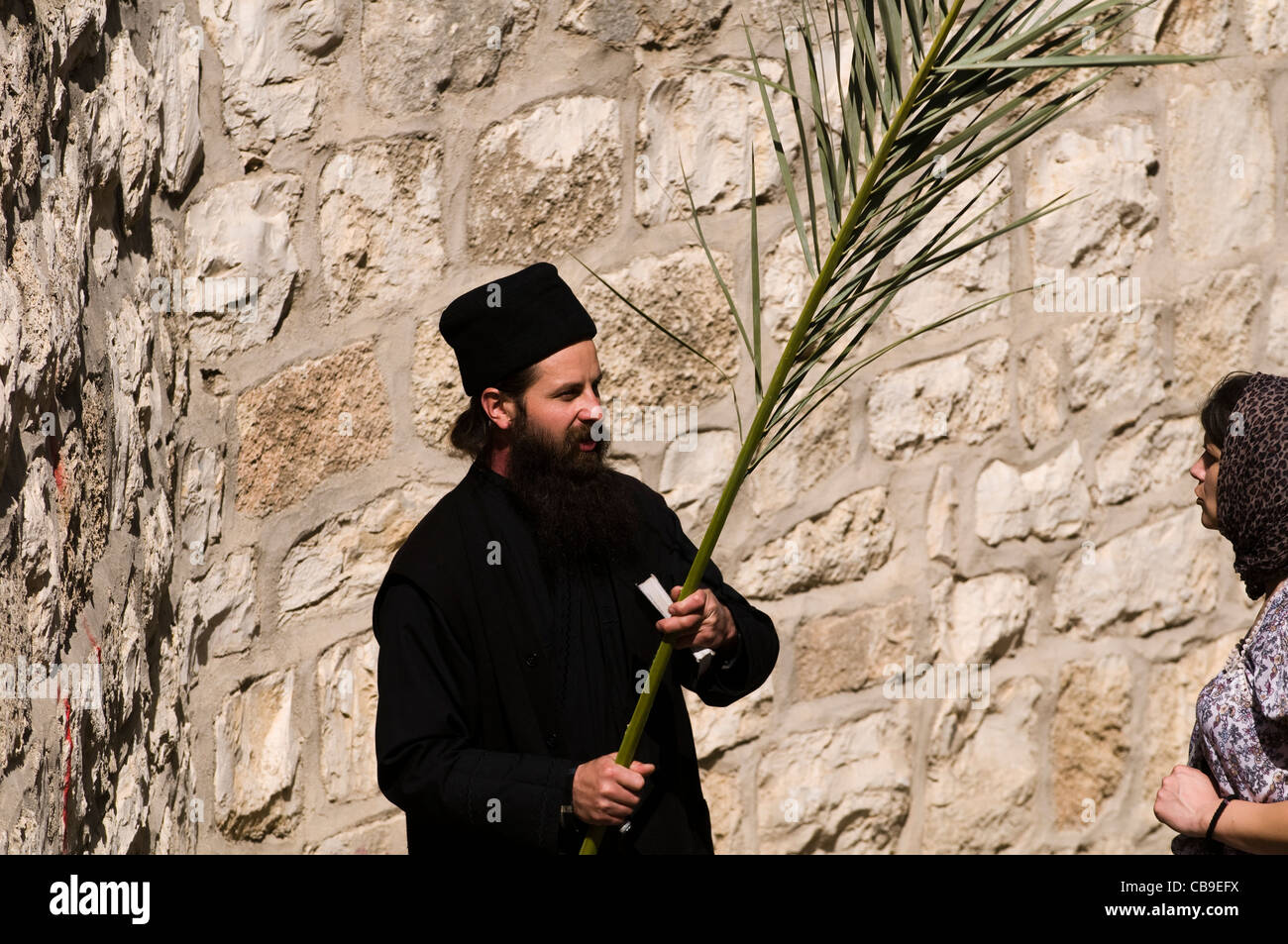 Un prêtre orthodoxe russe tenant une branche de palmier sur le Dimanche des jours. Banque D'Images