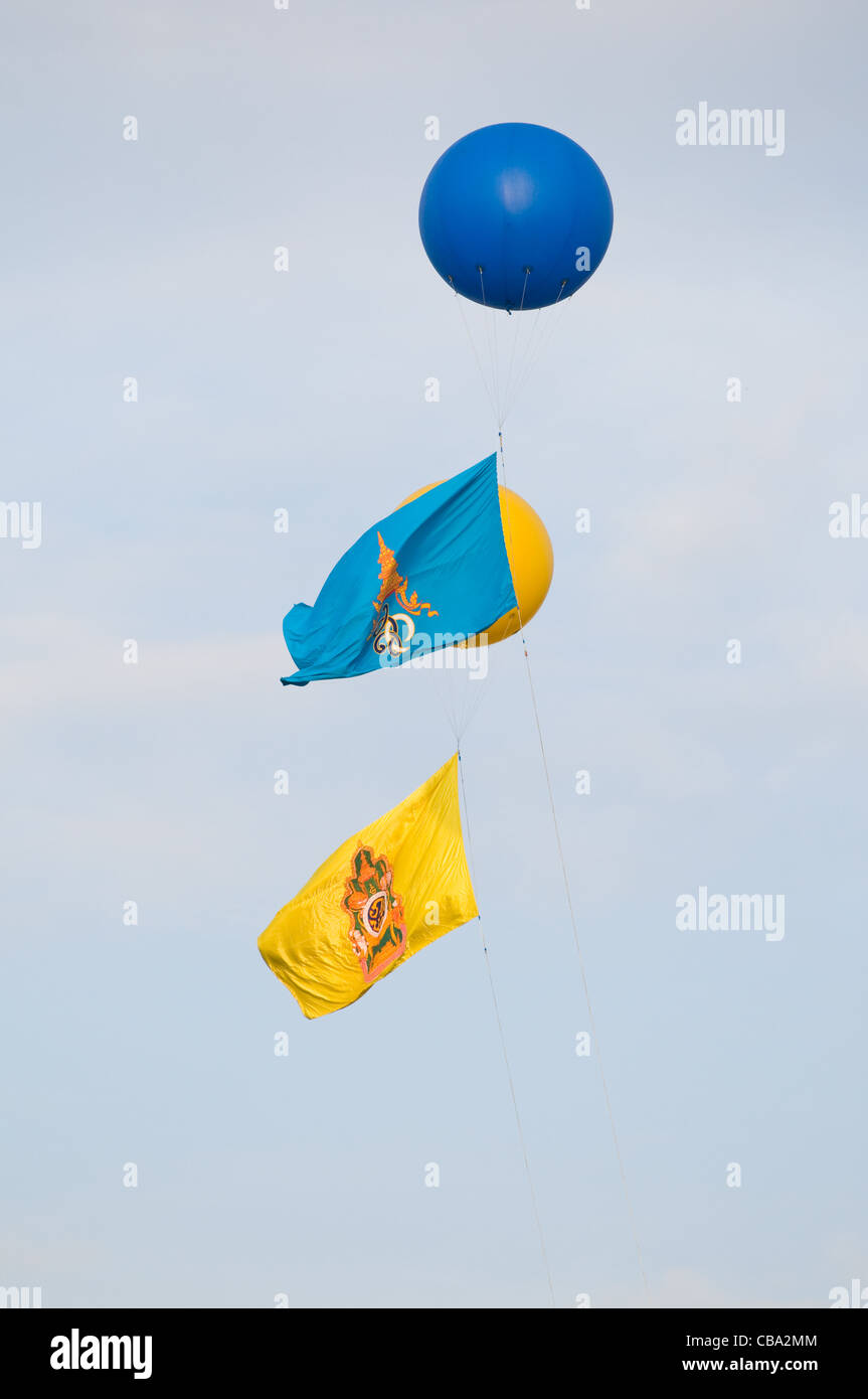 Drapeaux avec le monogramme de Sa Majesté la Reine Sirikit (bleu) et de sa Majesté le Roi Bhumipol Adulyadej (jaune) de la Thaïlande Banque D'Images