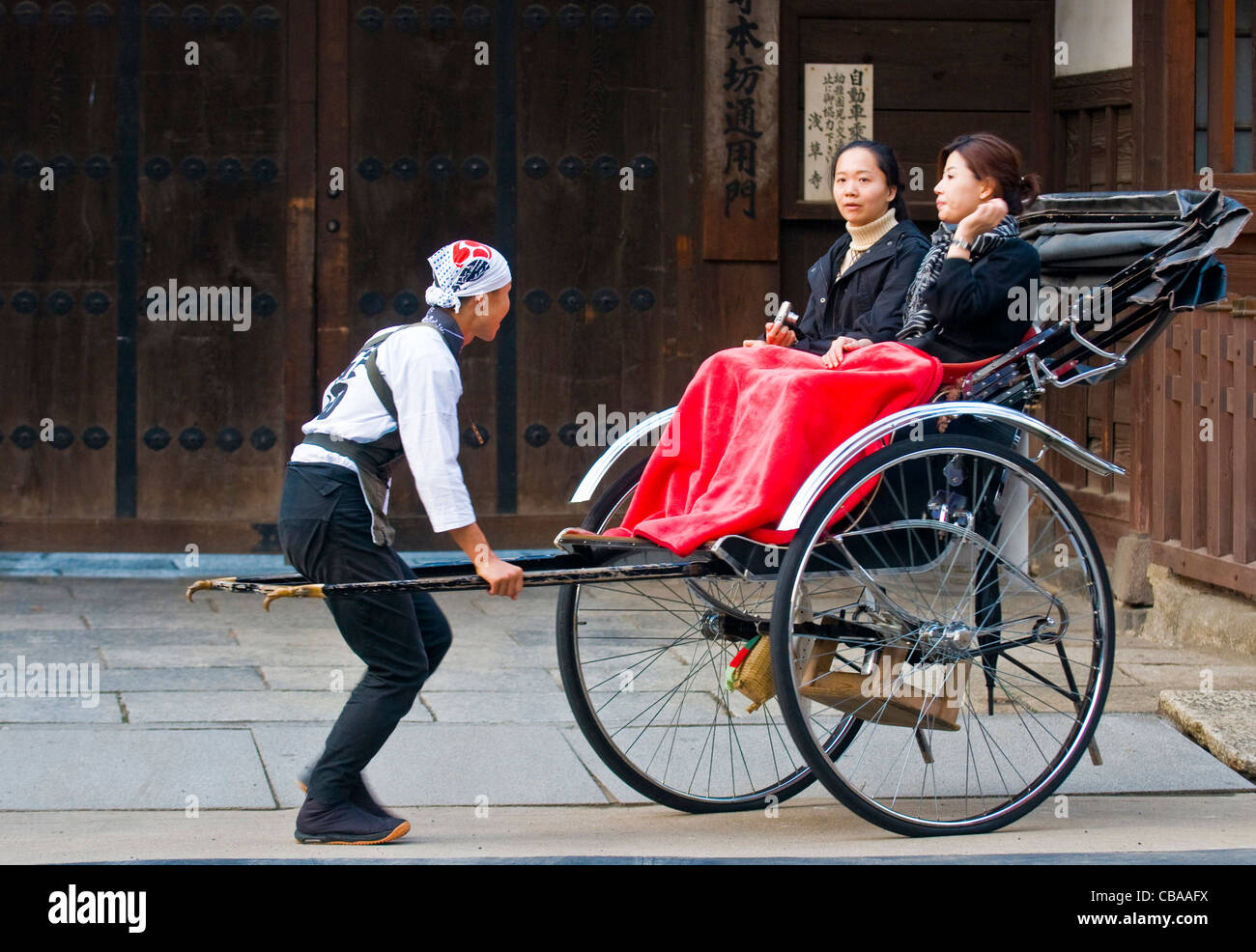 Couple japonais siège sur un pousse-pousse traditionnel à Tokyo , Japon Banque D'Images