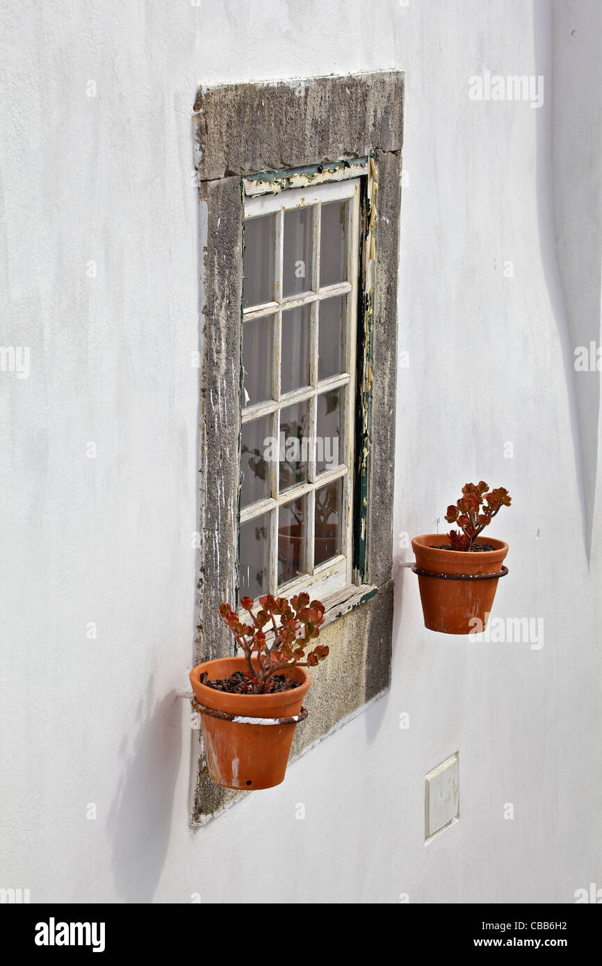 Sculpté en pierre fenêtre sur un mur de plâtre blanc brillant Banque D'Images